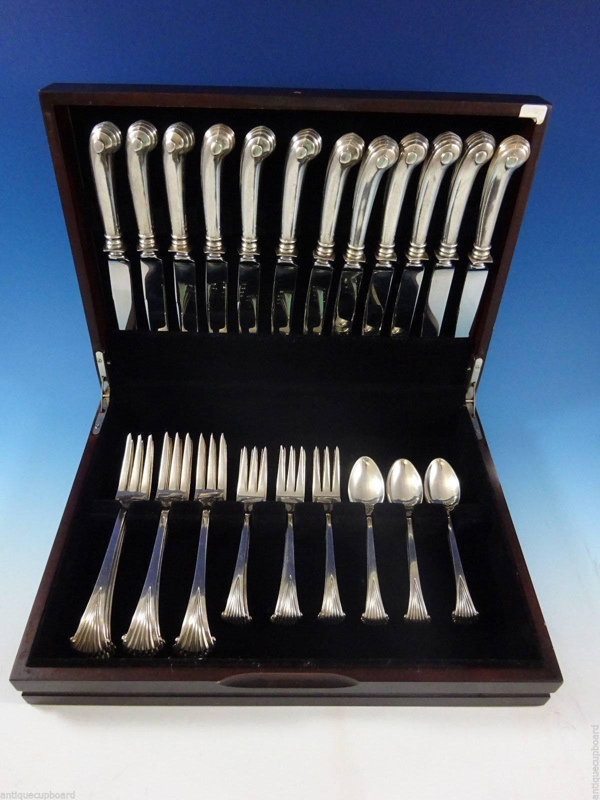 Onslow by Tuttle sterling silver dinner size flatware set, 48 pieces. This pattern is heavy with wonderful pistol-grip handles on the knives. This set includes: 

12 dinner size knives, 9 5/8