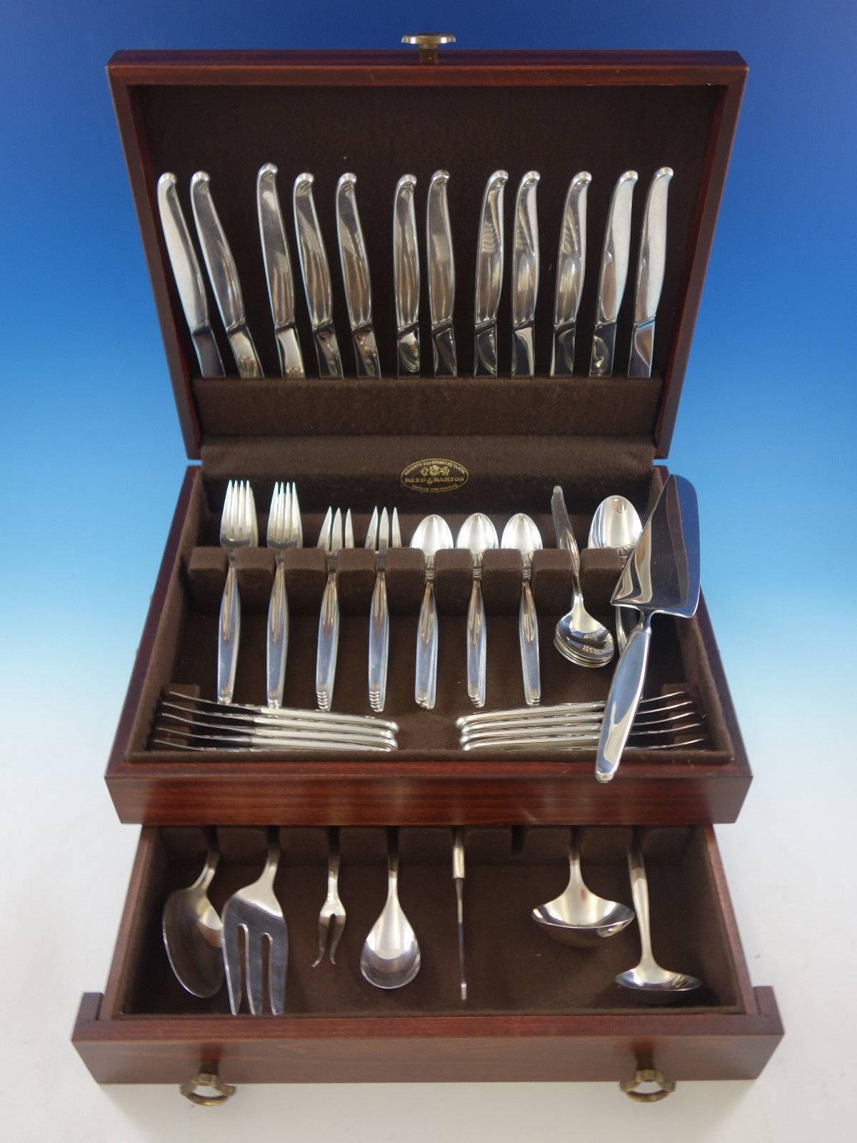 Contour by Towle Mid-Century Modern sterling silver flatware set, 80 pieces. The knives in this pattern are especially unique with unusual blades set on an angle. This set includes: 

12 knives, 8 3/4