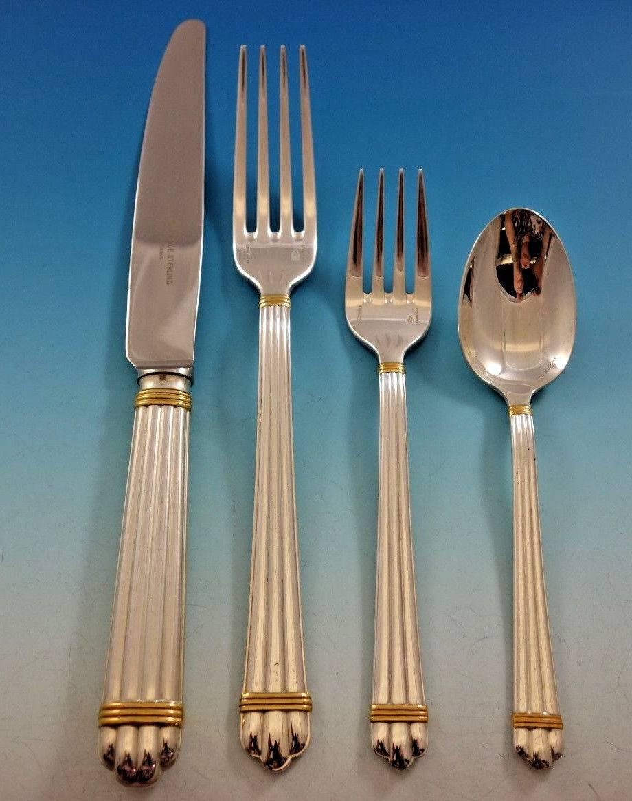 Aria gold accent by Christofle France sterling silver dinner flatware set, 32 pieces. This set includes: eight dinner knives, 9 3/4", eight dinner forks, 8 1/8", eight salad forks, 6 1/2", eight teaspoons, 6"

Includes bonus