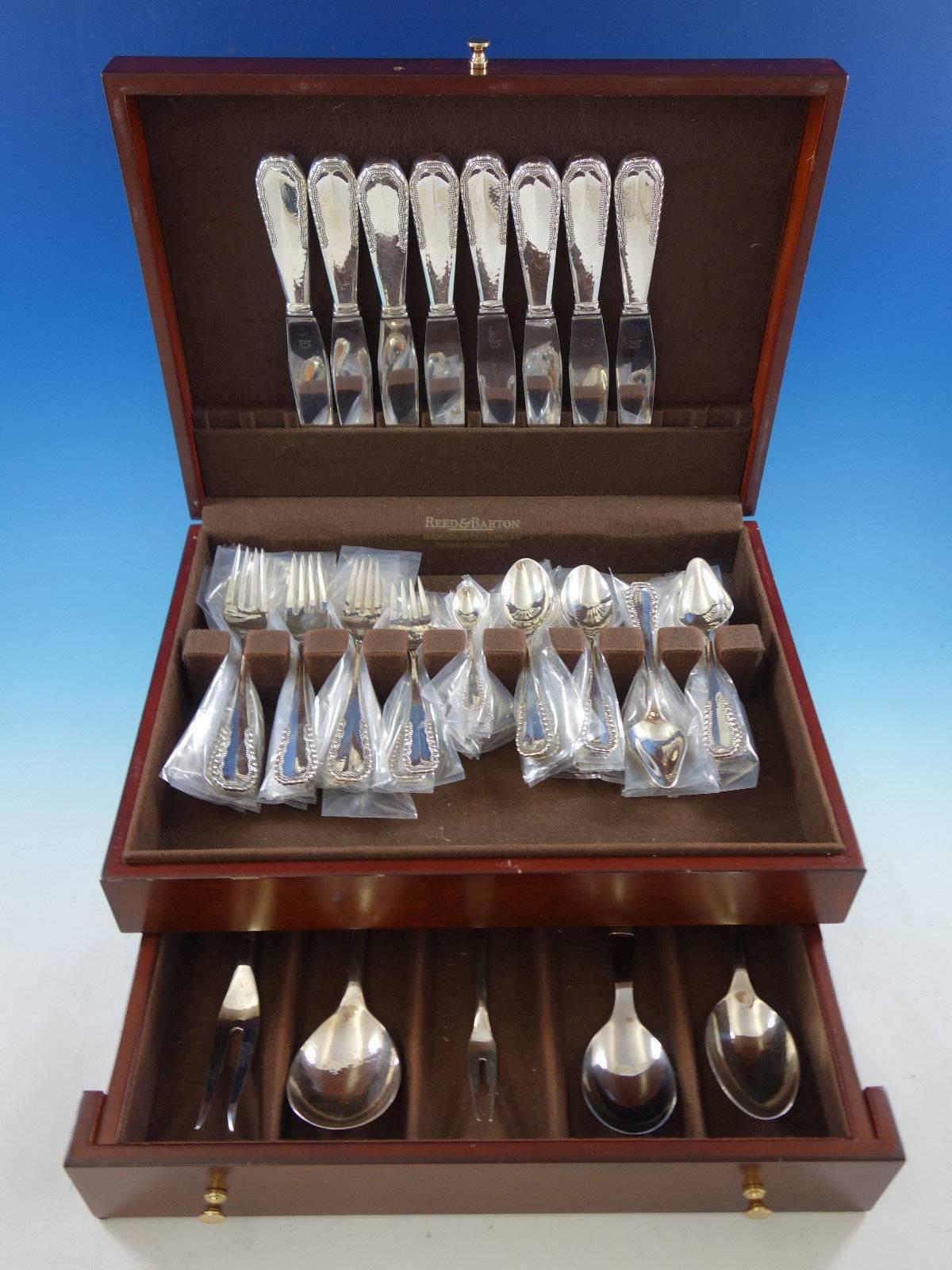 Exquisite Viking aka Nordisk by Georg Jensen, circa 1927, sterling silver flatware set, 53 pieces. The pattern features a beaded design and beautiful subtle hand hammering. This set includes: Eight dinner size knives, 9