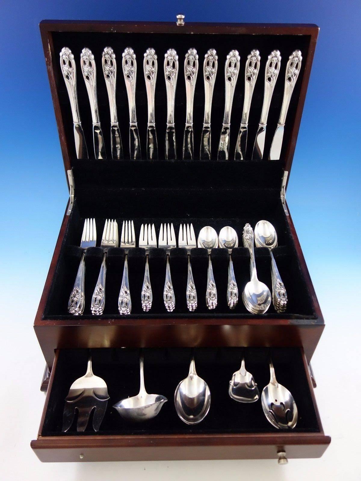 Silver Iris by International sterling silver flatware set with pierced handle, 65 pieces. This set includes: 

12 knives, 9