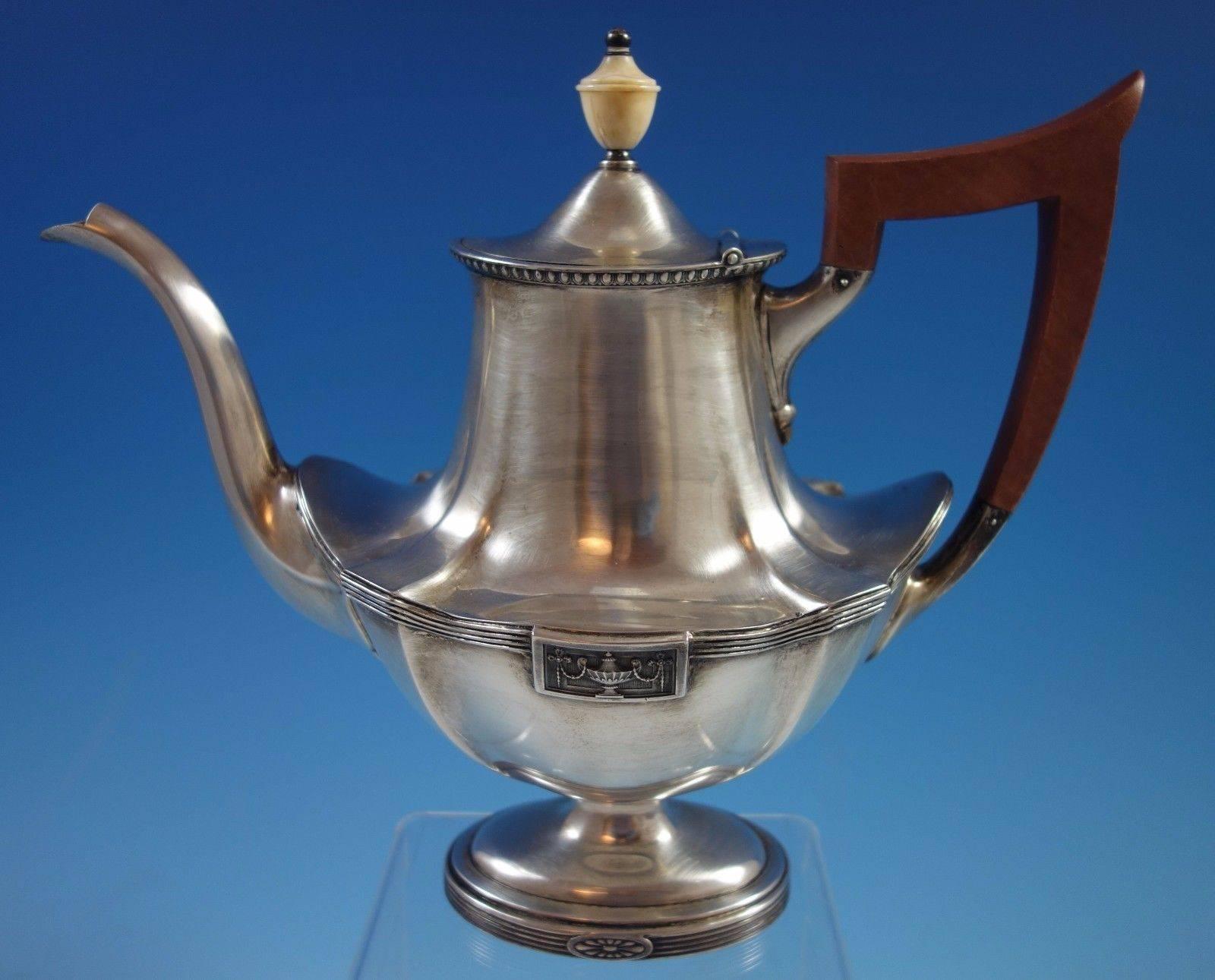 silver teapot with wooden handle