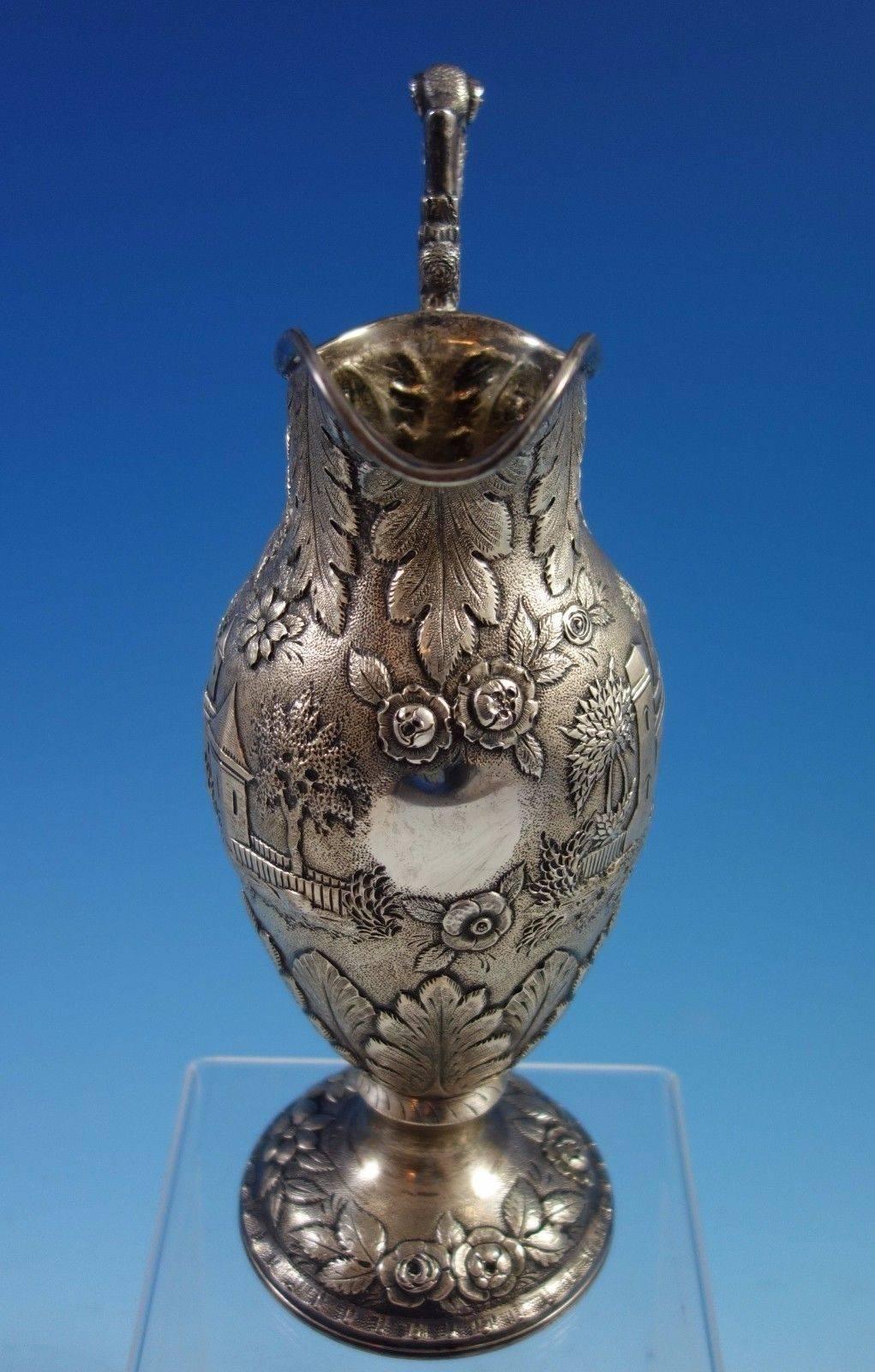 Repousse sterling silver Architectural milk pitcher handmade by A. G. Schultz of Baltimore, MD, and retailed by Hennegan and Bates. This impressive piece has repoussed architectural design including buildings/castles, trees, bird, and more. The