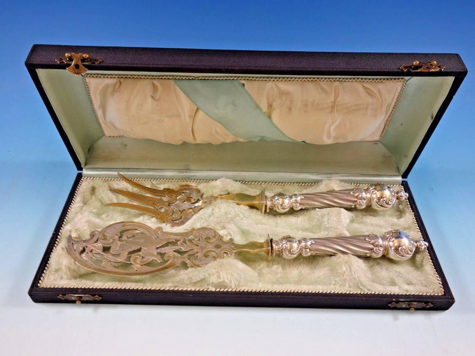 Gorgeous European art silver .800 art silver fish serving set, two-piece, with large bulbous column-like silver handles and partial gilt silver plate blades and tines. 

The knife measures 11 3/8