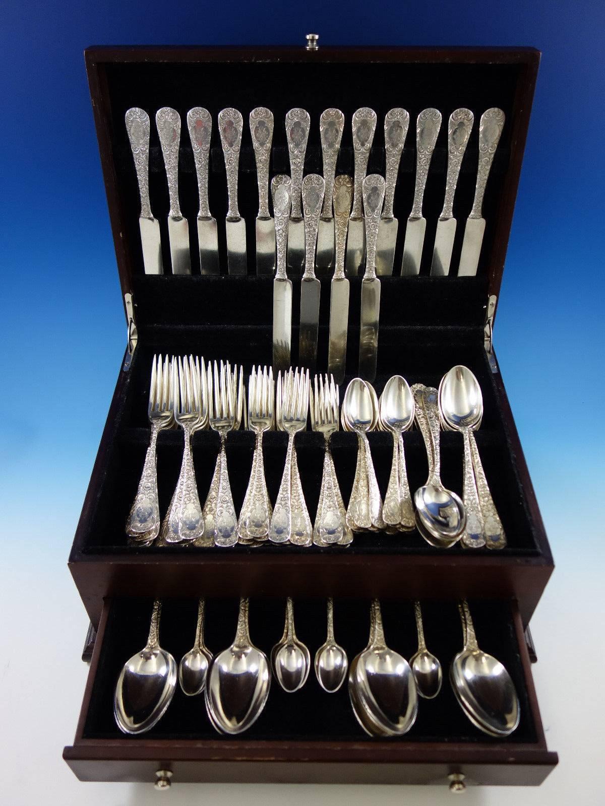 Monumental antique chased custom engraved pattern by Gorham sterling silver flatware set, 112 pieces. This scarce pattern is not shown in any of our books. It is completely hand chased and has a cartouche in the centre with intricate matching