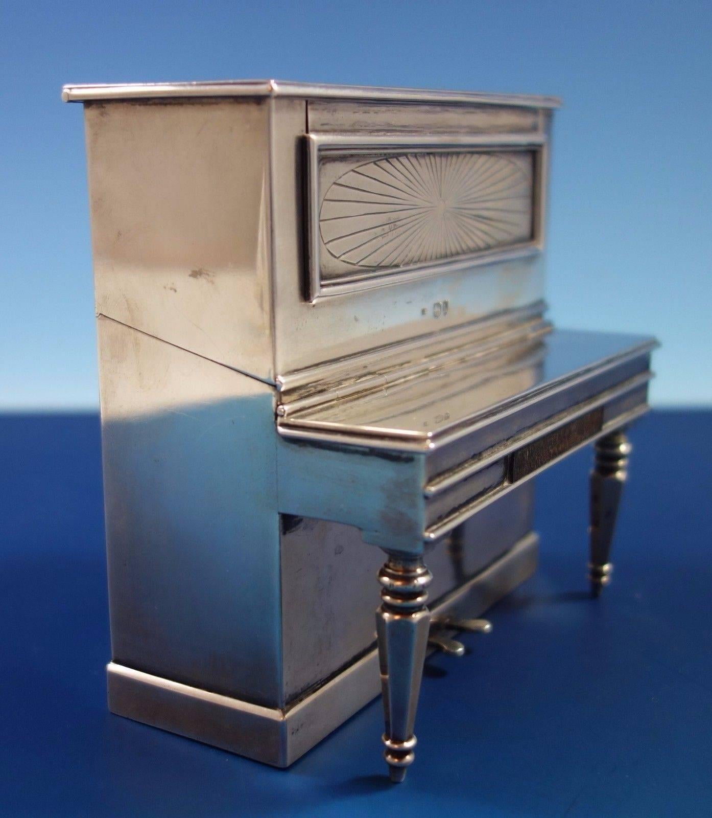 Fascinating English sterling silver cigarette box with match safe. The combo is in the form of a piano with three compartments. The piece dates from 1886 London and has an elaborate vintage monogram (see photos). The piece measures 4 1/2
