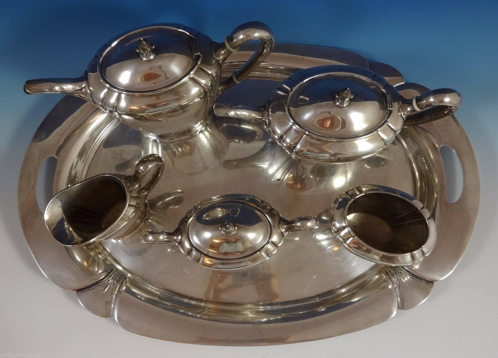 Orchid by International

Modernist Orchid by International sterling silver six pieces set. The five-piece tea set is marked with #C322, and the tray is marked with #W300-23. The set includes:

Coffee pot: Holds 10 cups, measures 9