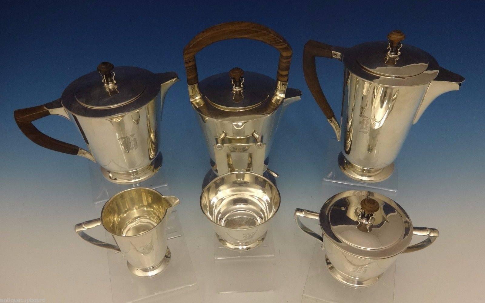 International Tea Set.

This exquisite six-piece sterling silver tea set was made by International. The pieces have teak handles and finials and the set dates from the 1950s. 
The set includes:

Kettle on stand: Holds 2 pints, it's marked with