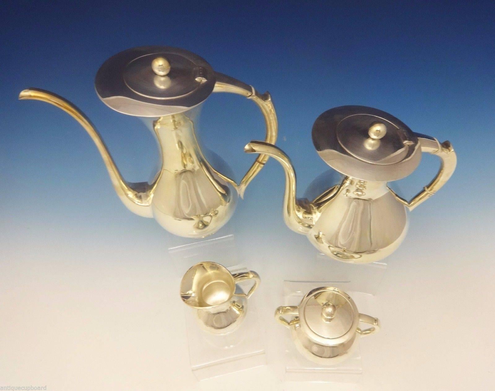 Emil Hermann
 
This Mid-Century modernistic four-piece sterling silver tea set was made by Emil Hermann of Germany circa 1921-1950s. The pieces are modernistic with ball finials. The set includes: 

Coffee pot: Measures 10 3/4