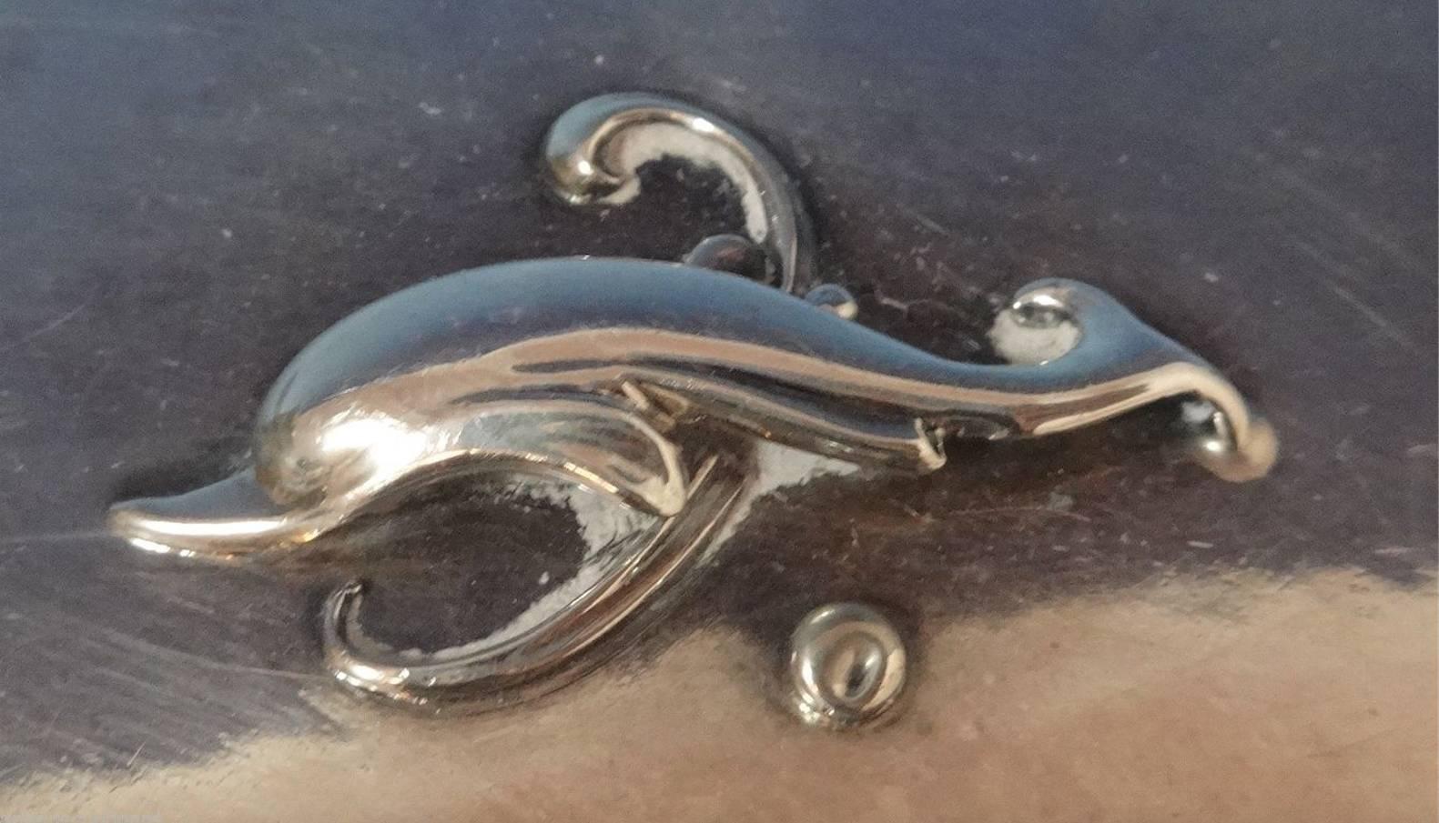 Dolphin by Georg Jensen.
Fabulous dolphin by Georg Jensen six piece sterling silver dresser set. All the pieces have GI marks. The brushes, mirror, and comb are marked with #150, and the button hook and file are marked with #154. The set