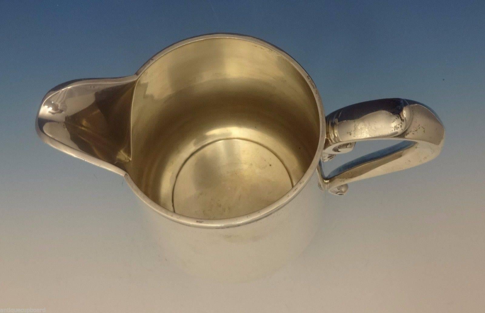 Richard Dimes.

This fabulous sterling silver water pitcher was made by Richard Dimes. The piece is a reproduction of the style of the mid-1700s and is engraved 