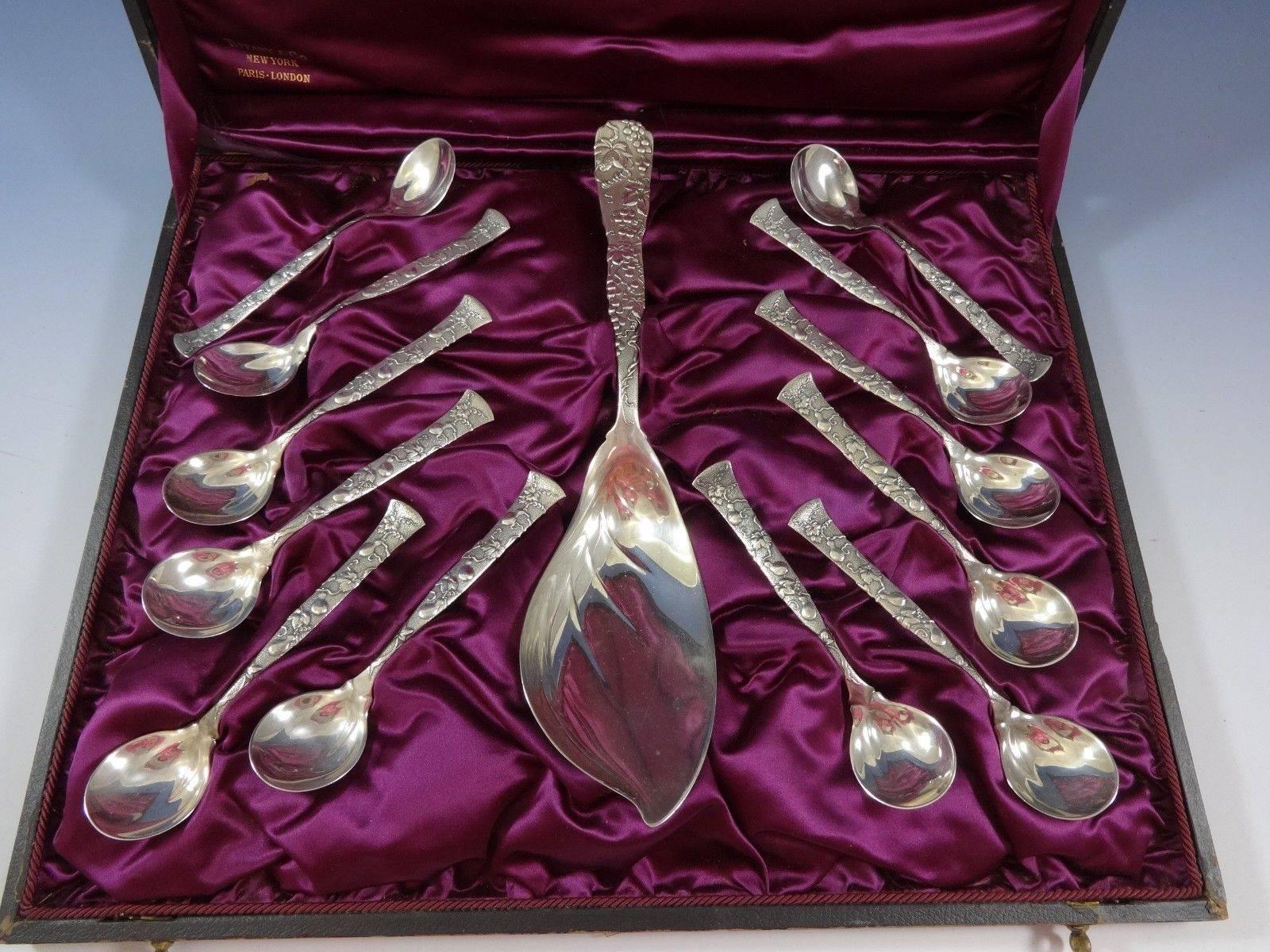 Vine by Tiffany & Co.

Sterling silver Tiffany vine ice cream serving set containing 12 pinched sorbet spoons (5 ¾”) and one ice cream/sorbet server (11 ¼”), monogrammed on reverse. Interior of box excellent. Exterior of box – poor condition.