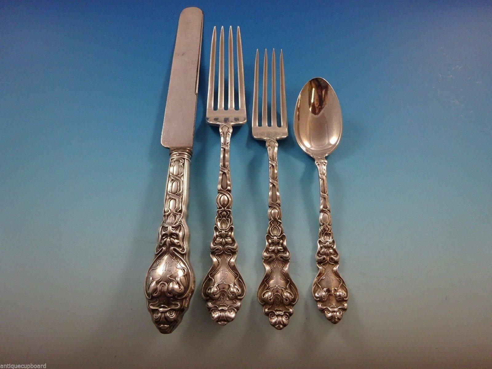 Exceptional Figural Art Nouveau Douvaine by Unger sterling silver flatware dinner size set of 57 pieces. This pattern features a stylized dolphin and the face of the North Wind. This set includes:

Eight dinner knives, 9 1/2