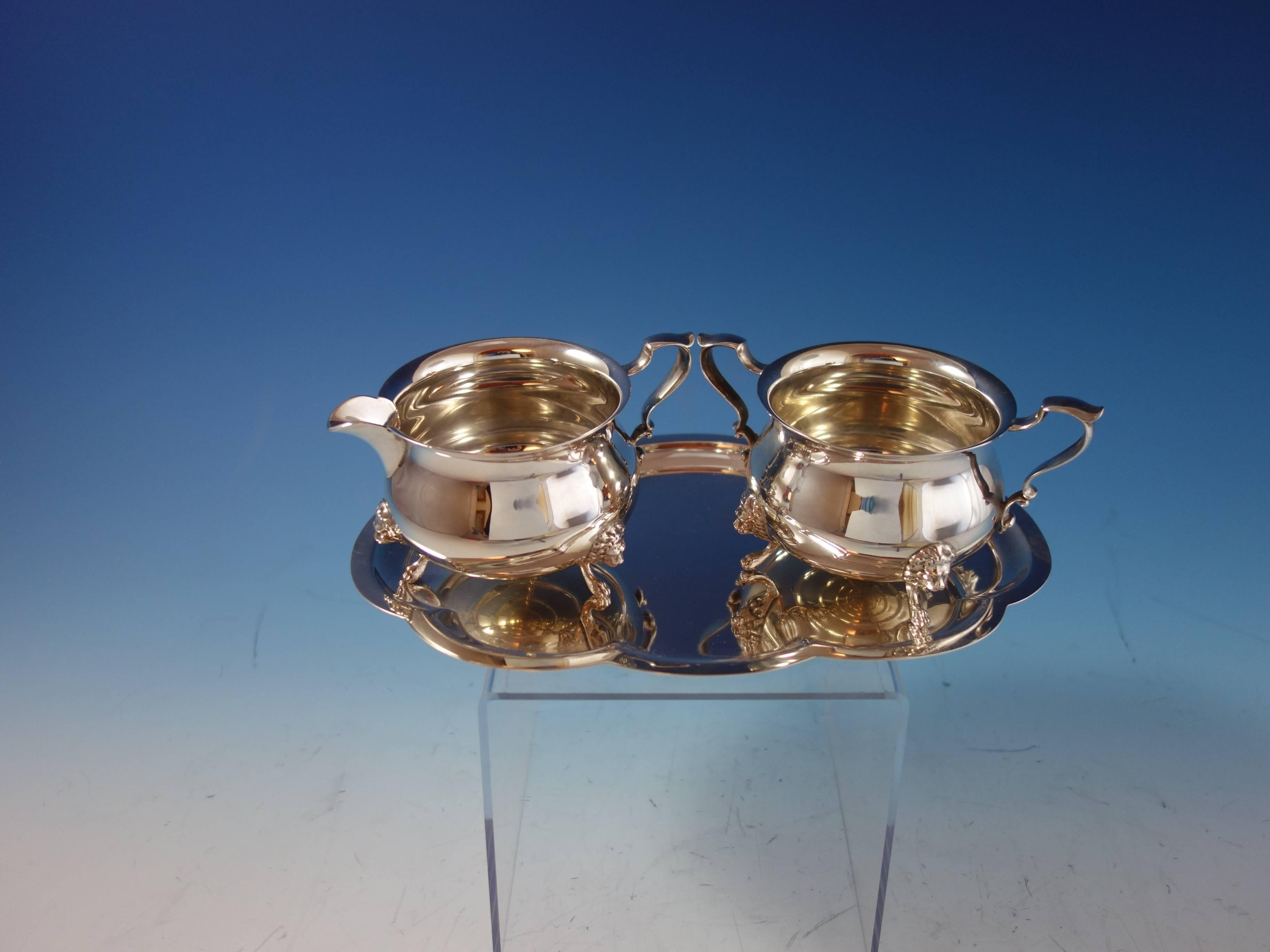 Marvelous Georgian by Poole three-piece sterling silver set that includes a creamer, sugar, and a tray. The sugar and creamer have applied lion head feet. All the pieces are marked with #33. The creamer measures 2 3/4