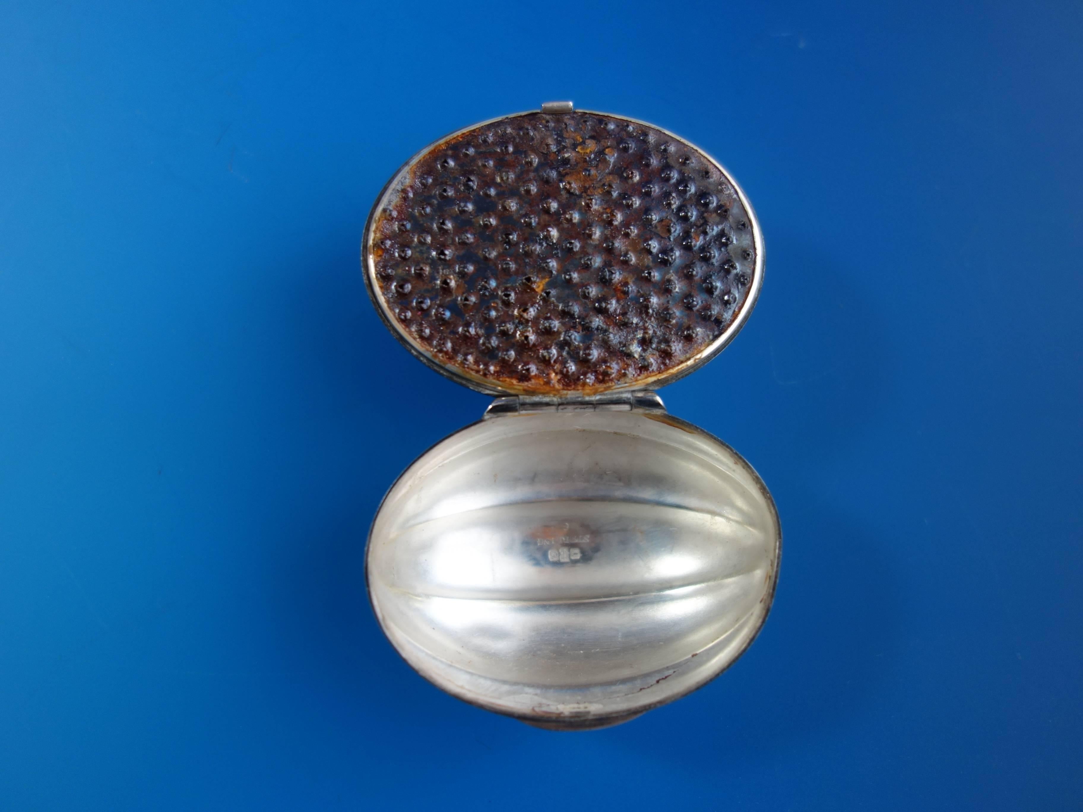 Sterling silver nutmeg grater made by Gorham in the shape of a nutshell. The piece has a 