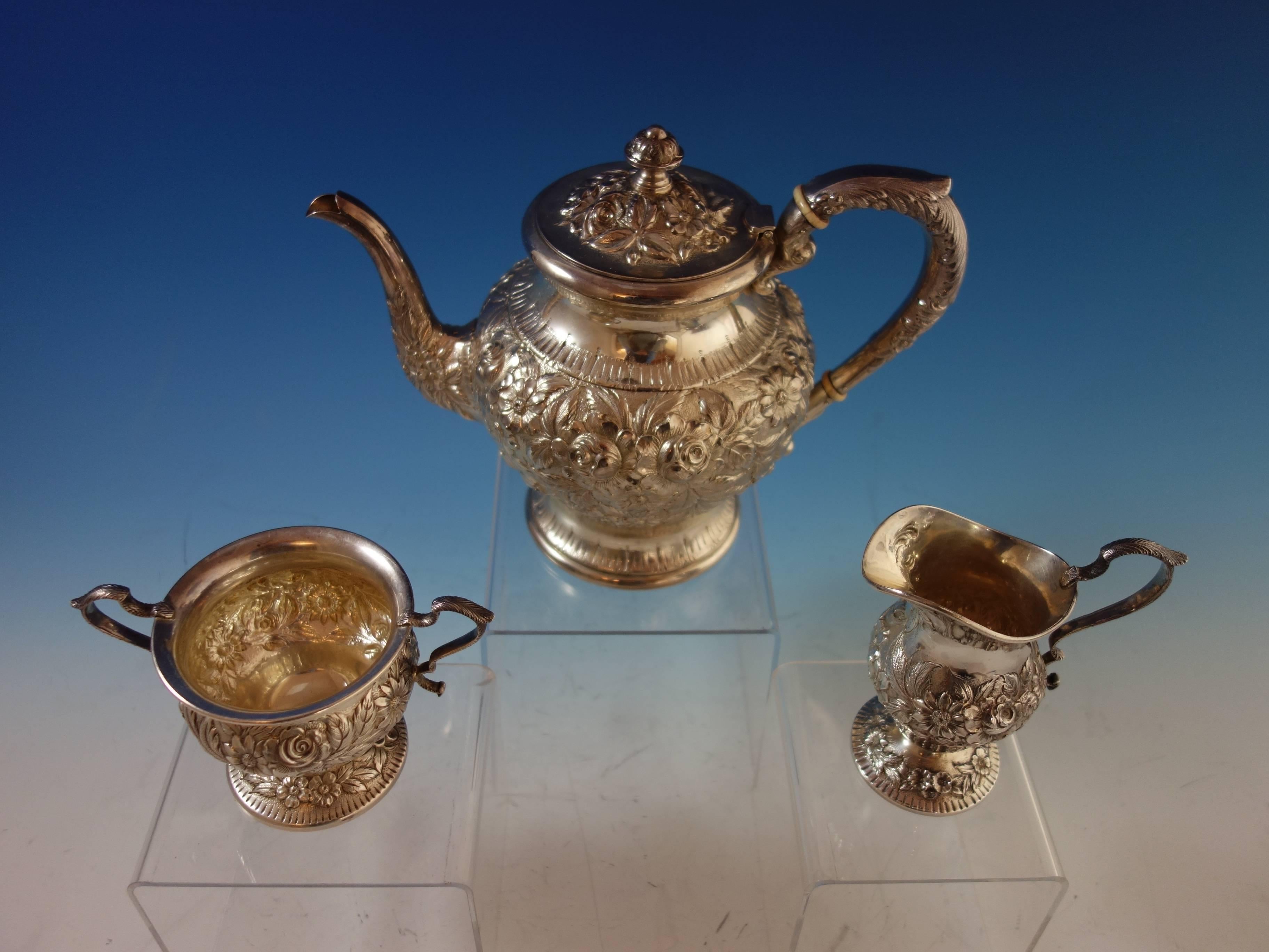 Repousse by Kirk sterling silver tea set all hand decorated. This three-piece tea set includes: 

One coffee pot: Marked #474, measures 9 1/2" x 8", and weighs 22.4 troy ounces. 
One sugar: Marked #184AF, measures 5 1/2" x 4",