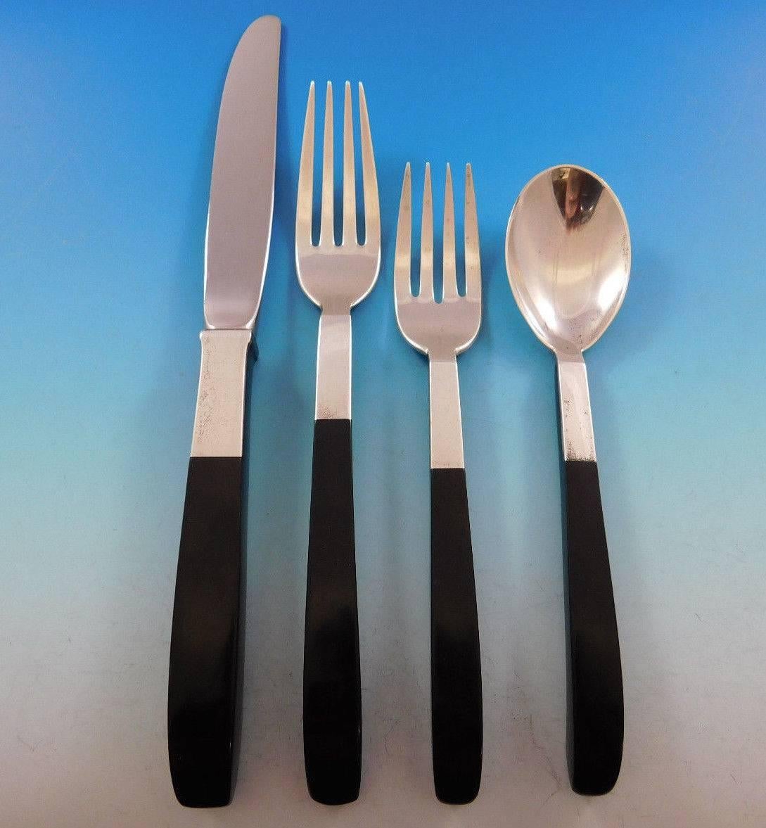 Mid-Century Modern Contrast by Lunt sterling silver with nylon handle flatware set, designed by Nord Bowlen of Greenfeld, MA in 1956. This modernism set of 32 pieces includes: 

Eight knives, 9 1/4