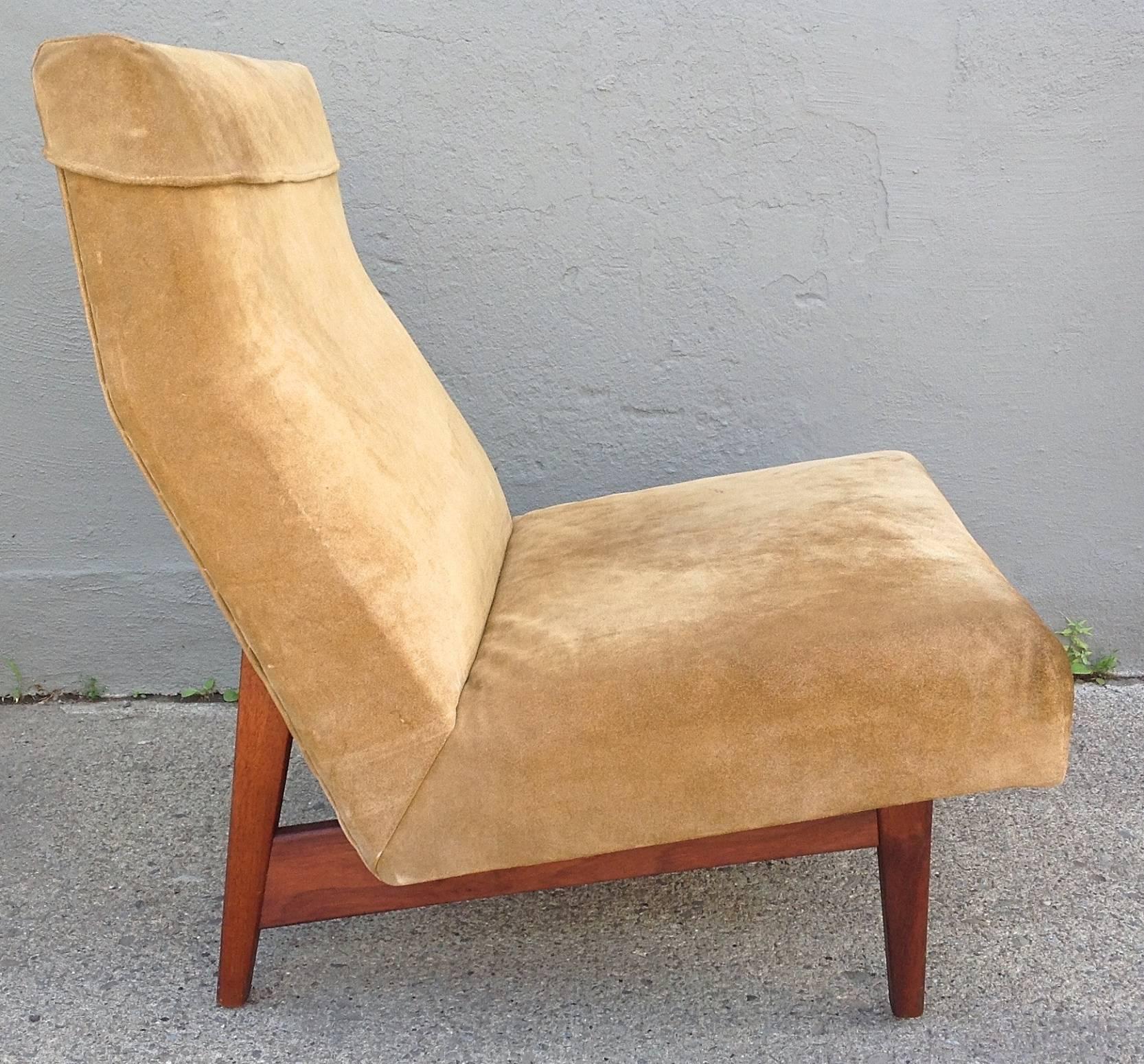 A wonderful example of a Jens Risom slipper chair in beautifully worn suede in warm tones of honey and aged moss supported by exposed walnut frame. Chair dates from the 1950s.