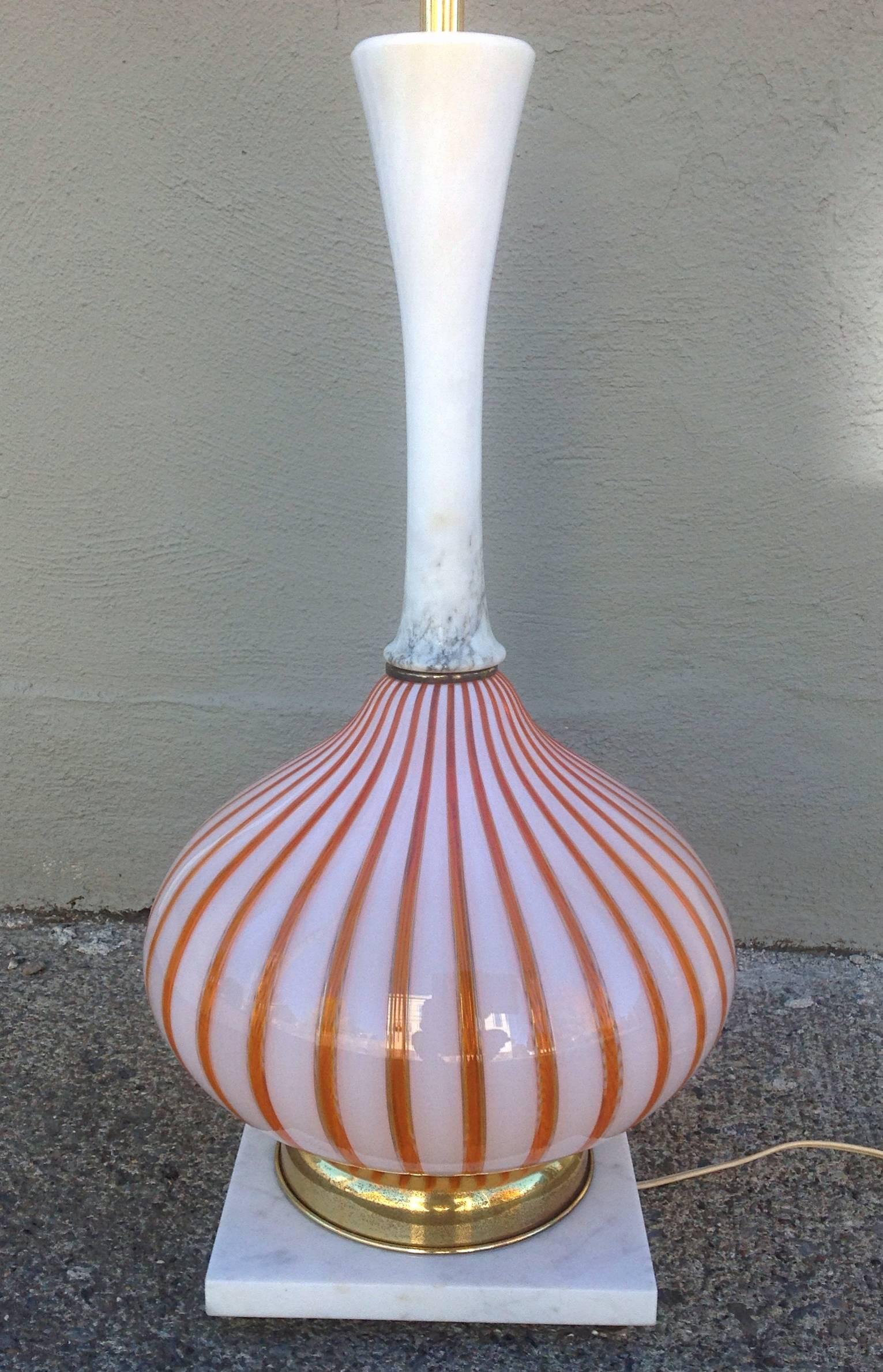 A beautiful Murano orange and white striped blown glass body in onion form with alabaster neck table lamp. Brass accents and marble base. Patina to brass parts and original wiring, Italian, circa late 1940s-early 1950s. 
29