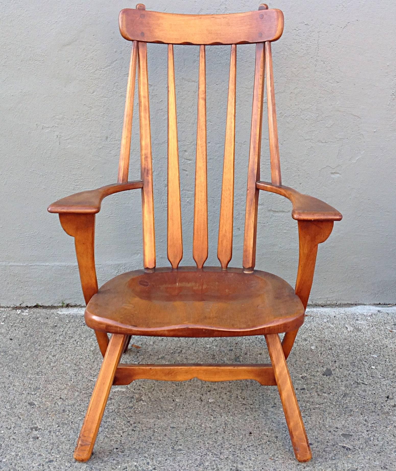 Solid maple armchair with saddle shaped seat, wide paddle arms and arrow spindle back. Similar to the Cushman designs of the 1930s this example was crafted by Sykes Furniture also mid-1930s. Retains its original finish with rich patina and age
