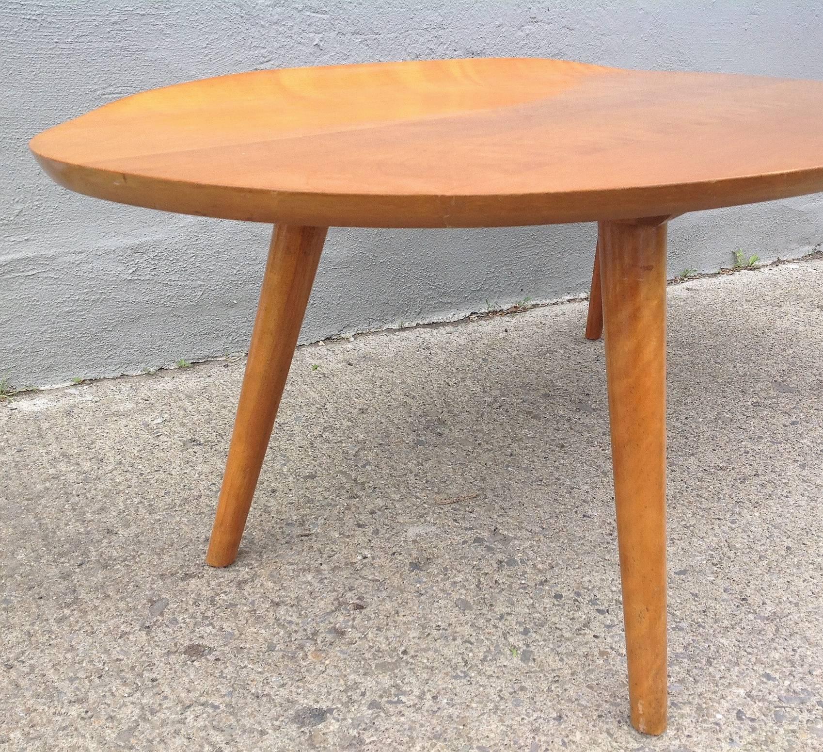 Russell Wright for Conant & Ball, circa 1950 honey maple table with dowel splayed legs. Warm patina, newly polished. Table surface 15.5"h. Age apprriate wear around feet.