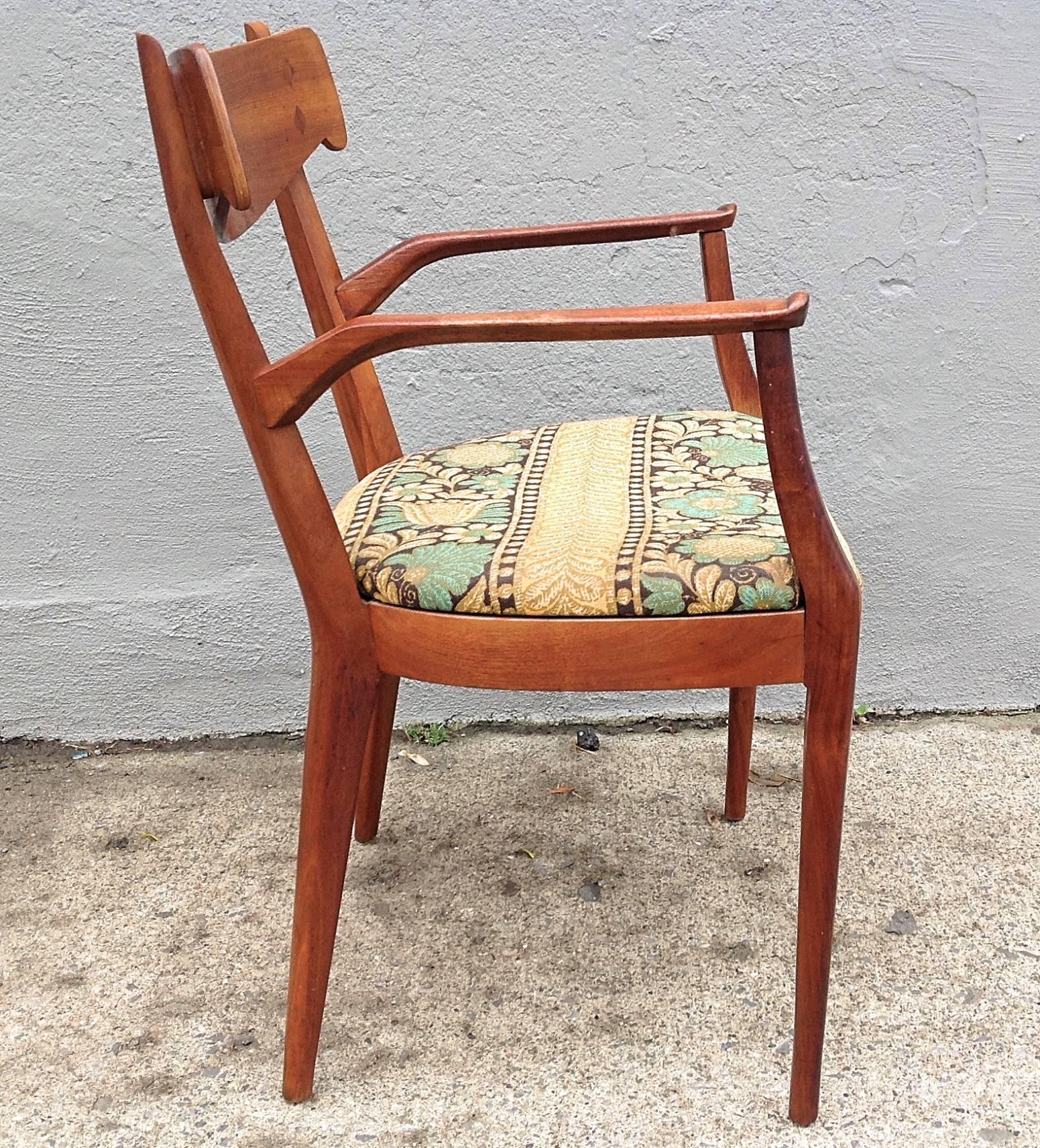 Graceful lines adorn these walnut dining chairs design by Kipp Stewart and Stuart MacDougall for Drexel, circa 1950. Set consists of two armchairs in vintage cotton tapestry and six side chairs in original white naugahyde. Very good vintage