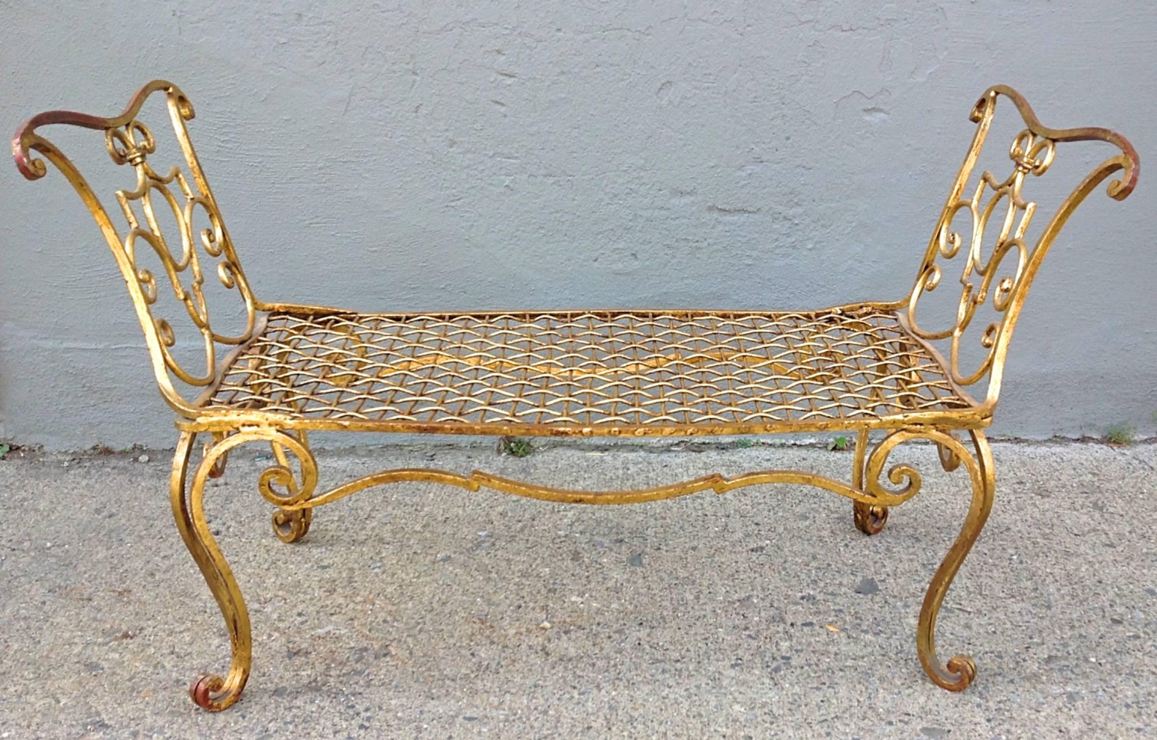 Jean Charles Moreux gilded wrought iron bench. Rich patina and wear to gilding. Leather button cushion.