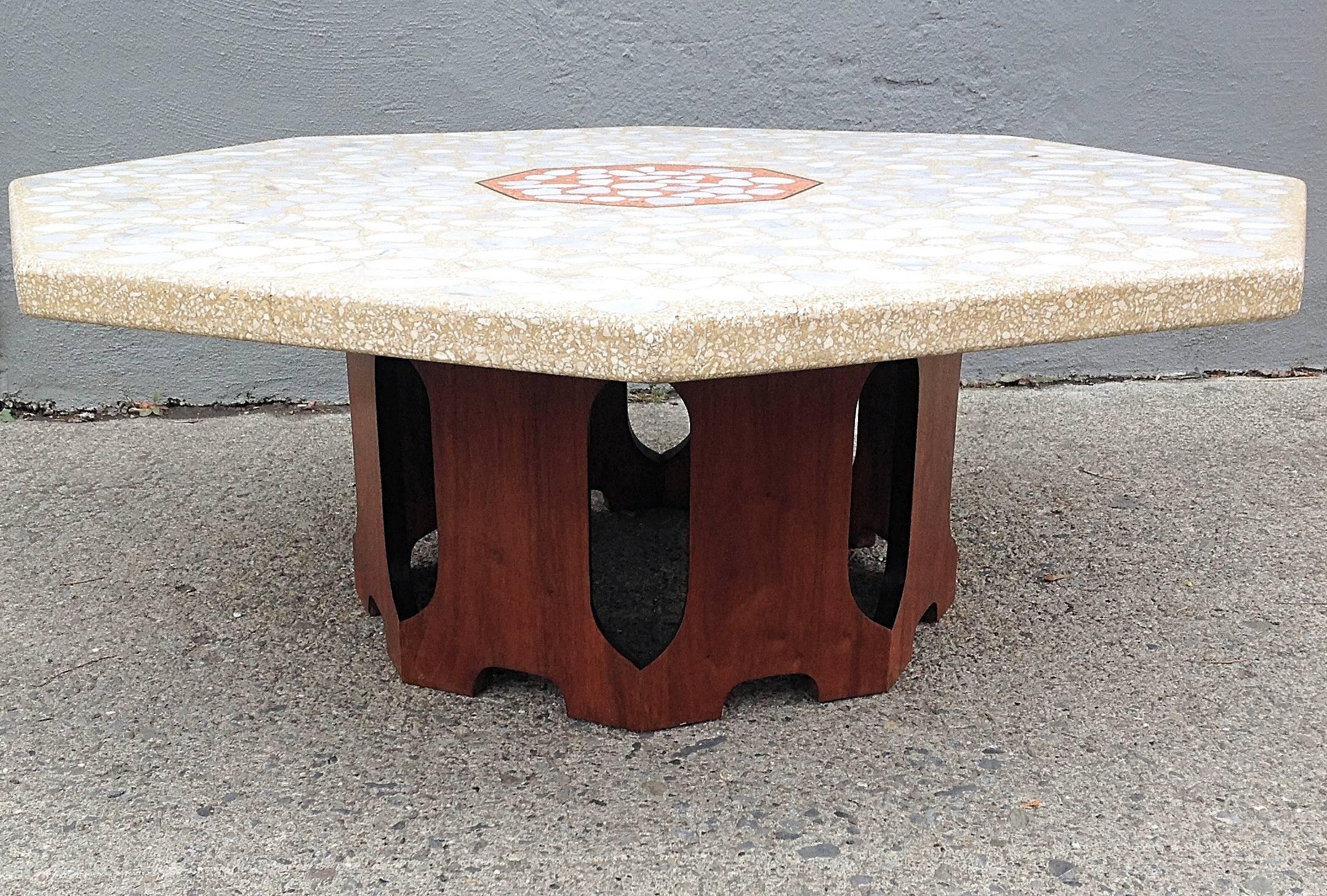 Large terrazzo octagonal low table by Harvey Probber.
Mixed aggregate, large stones small pebble. Contrasting orange center with brass detail. Walnut base with hex cutouts. Old repair veneer on base a shown.