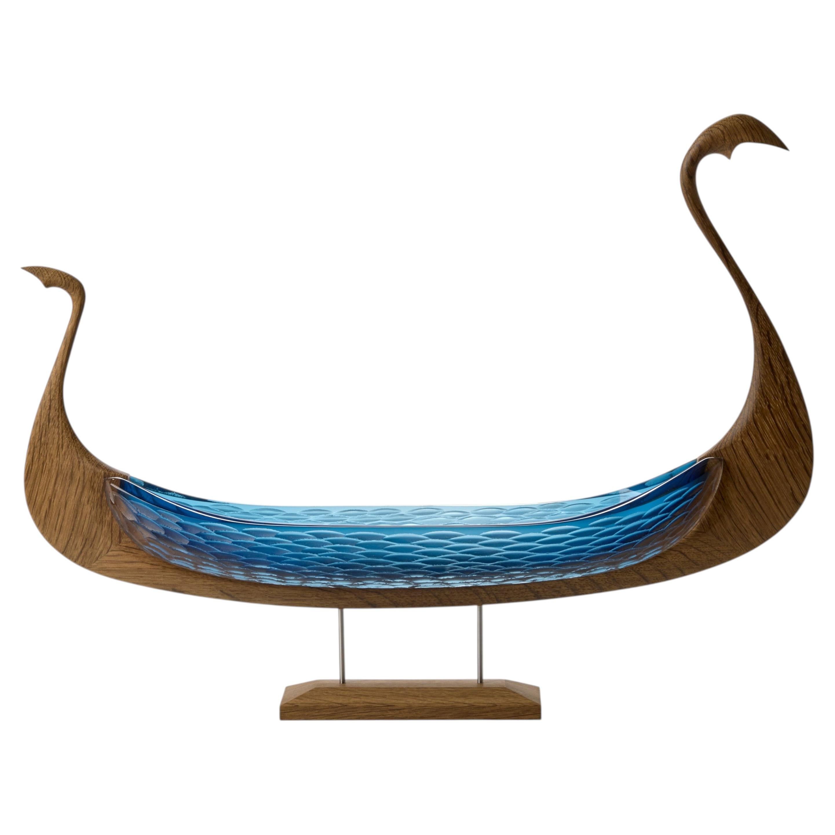 Snake Odin, a blue glass and wood viking boat by Backhaus & Brown and Egeværk