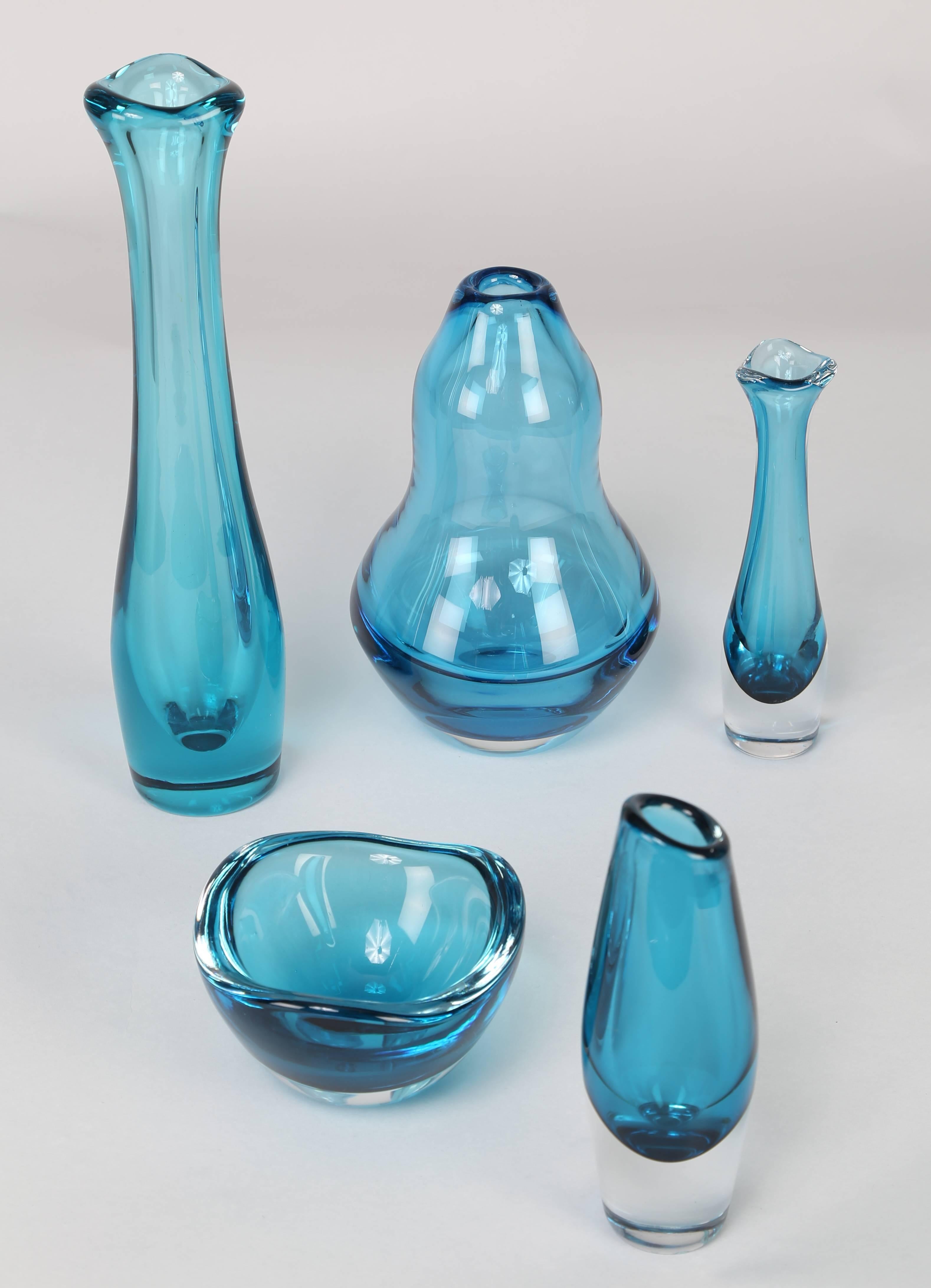 Five lovely blue-glass "Selena" vases by Sven Palmqvist for Orrefors, circa 1960s. Each signed. Clockwise from top left: 12-1/4" H x 3" W; 8" H x 5" W; 6-1/2" H x 2-1/2" W; 7" H x 2" W; 2-1/2" H
