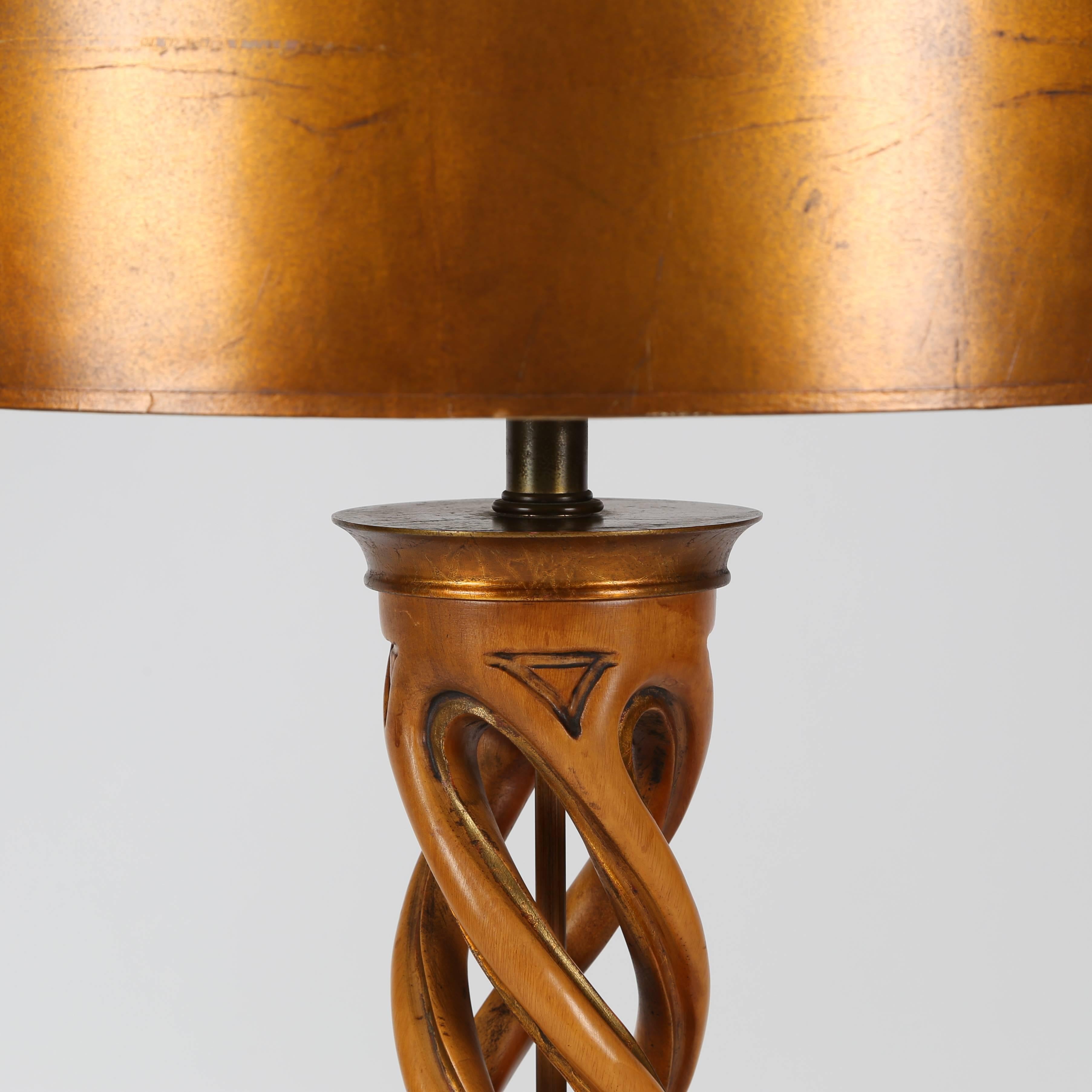Exceptional carved helix table lamp in bleached mahogany with gilt accents, gilt base and cap, and original gilt shade and finial. Glass diffuser supports the shade. Uses a three-way mogul bulb. All original, except for new wiring. Manufactured by