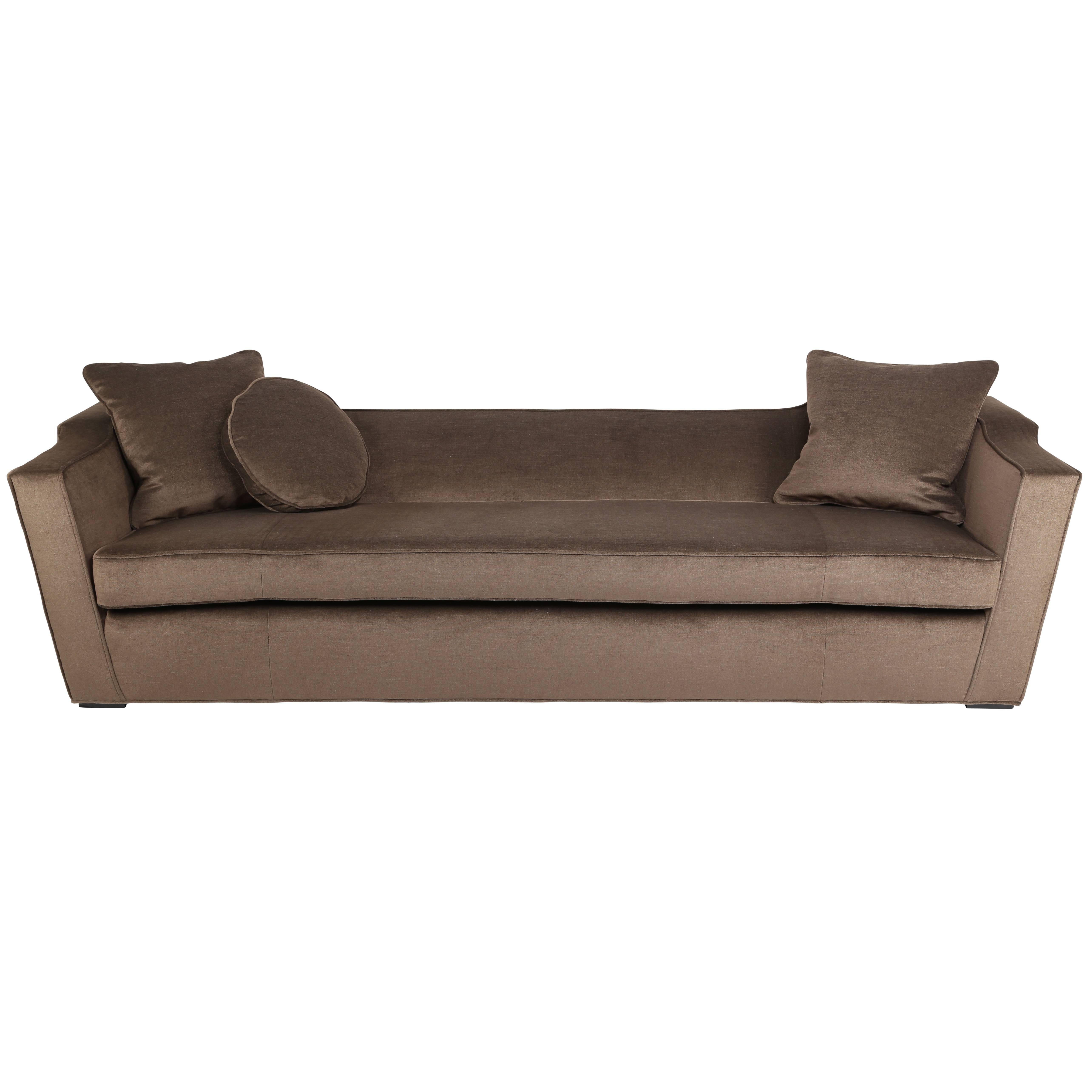 Large-scale sofa by James Mont beautifully reupholstered in a luxurious and durable chocolate-brown mohair velvet. The flared arms and back feature a raised detail that adds interest to an otherwise streamlined design. Beautifully built in the 1950s