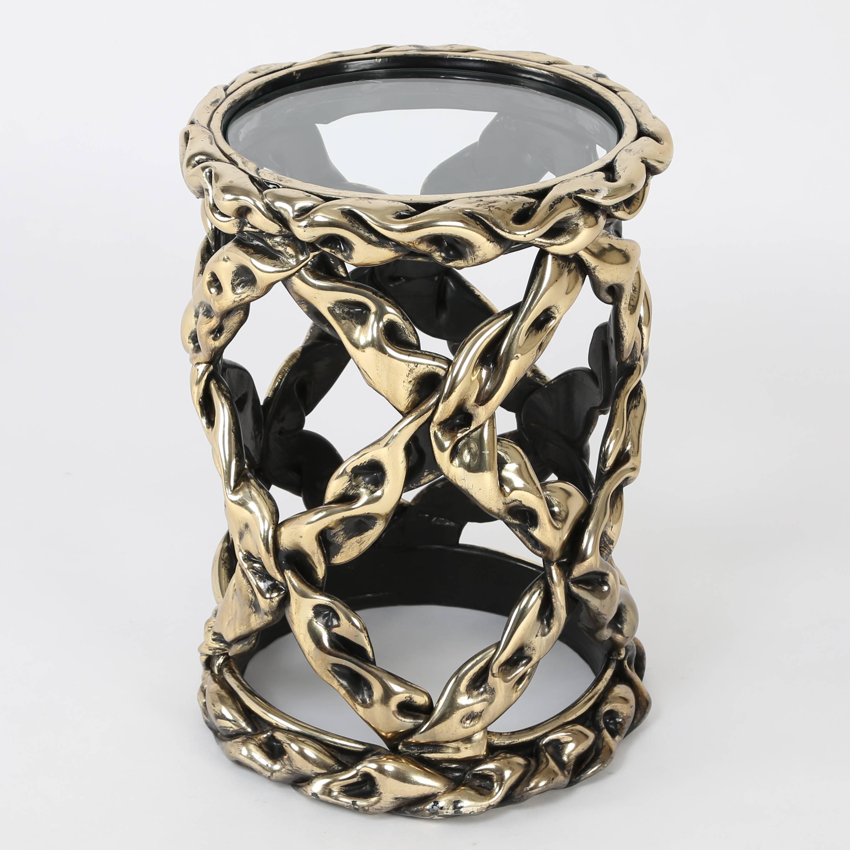 The twisted and interwoven strands of brass and black hued resin lend this table a sense of Brutalist chic, two words we don't often use to describe the same piece of furniture. A great and unusual accent piece. Marked with a 