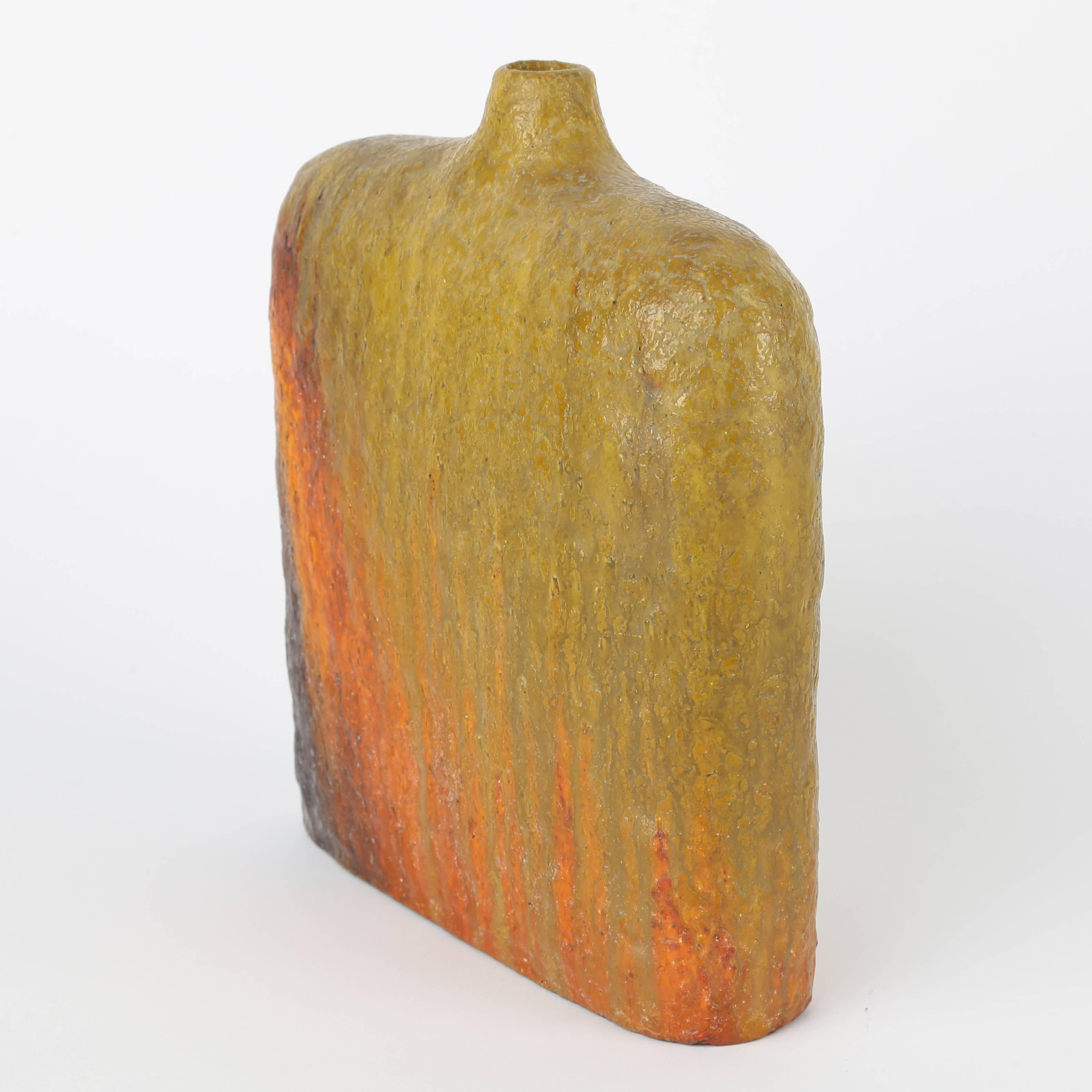Lovely glazed-ceramic vase in hues of orange, green, red and brown. 