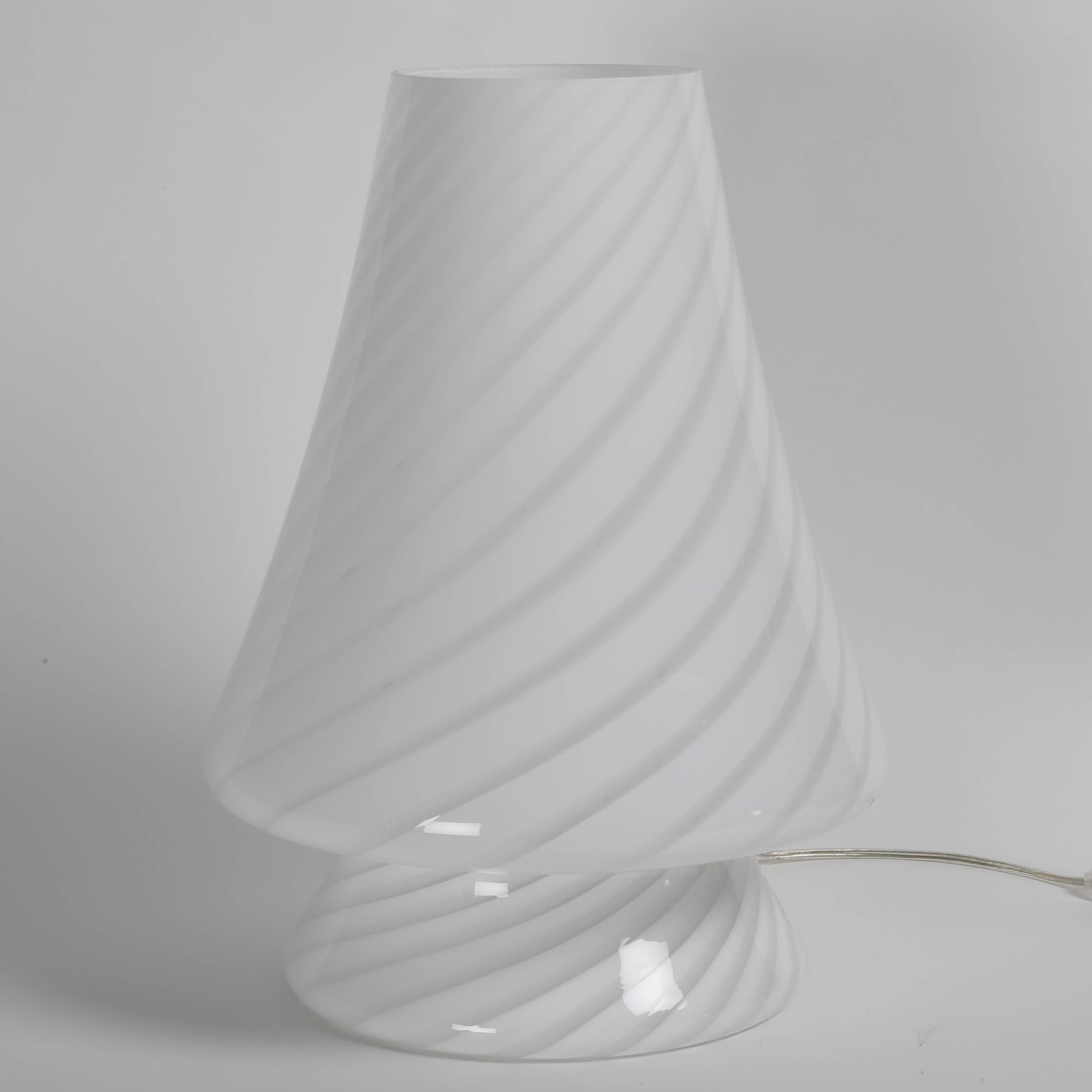 Beautiful single piece, all-glass accent lamp in swirls of clear and opaque handblown Murano glass. 75-watt maximum standard-base bulb.  This item is at the 1stdibs Gallery at the New York Design Center, 200 Lexington Ave., 10th floor, New York,