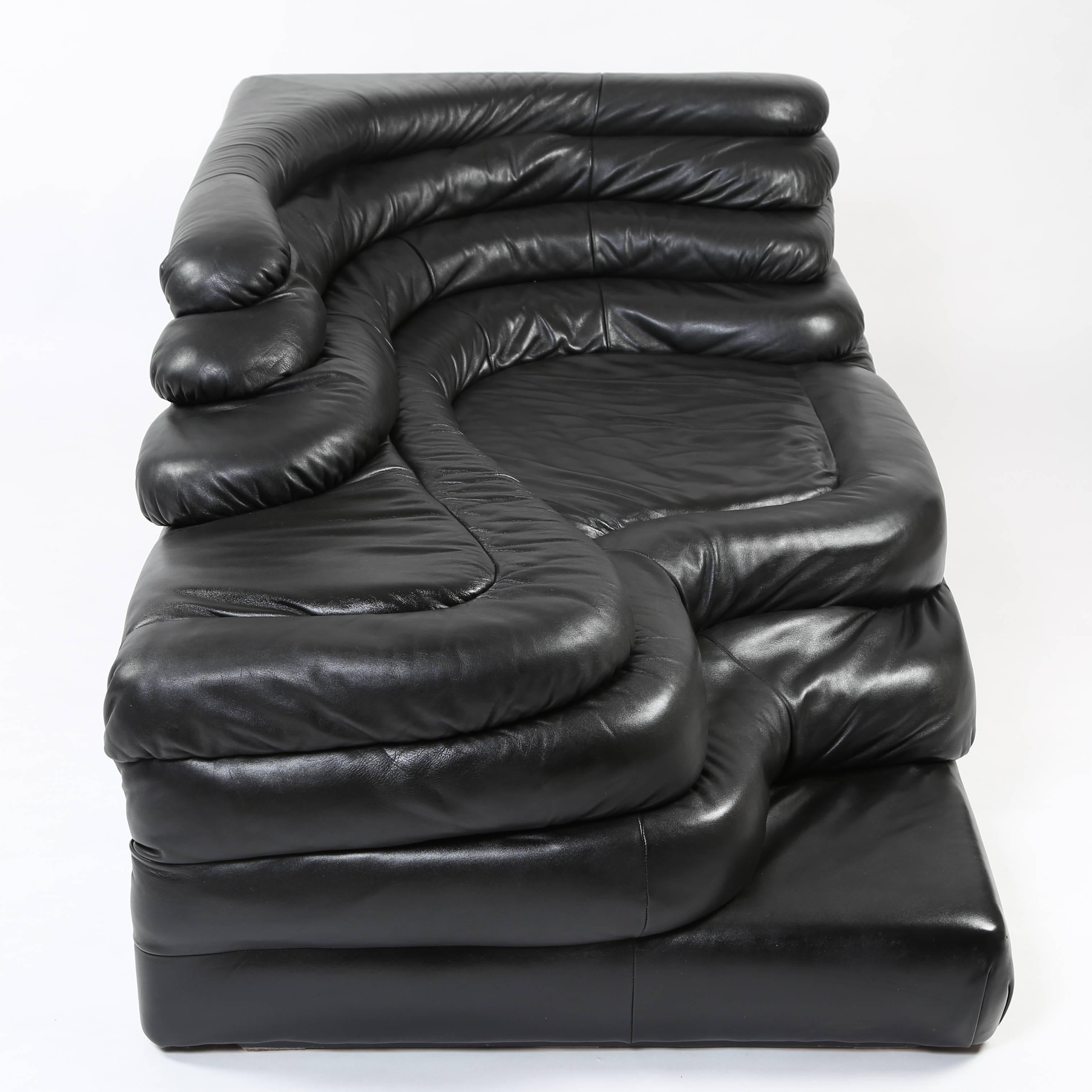 This unique piece of lounge seating in black leather from Ubald Klug's iconic Terrazza Furniture system will lend any room a dash of 1970s decadence. Leather newly restored. This item is in our Brooklyn showroom.