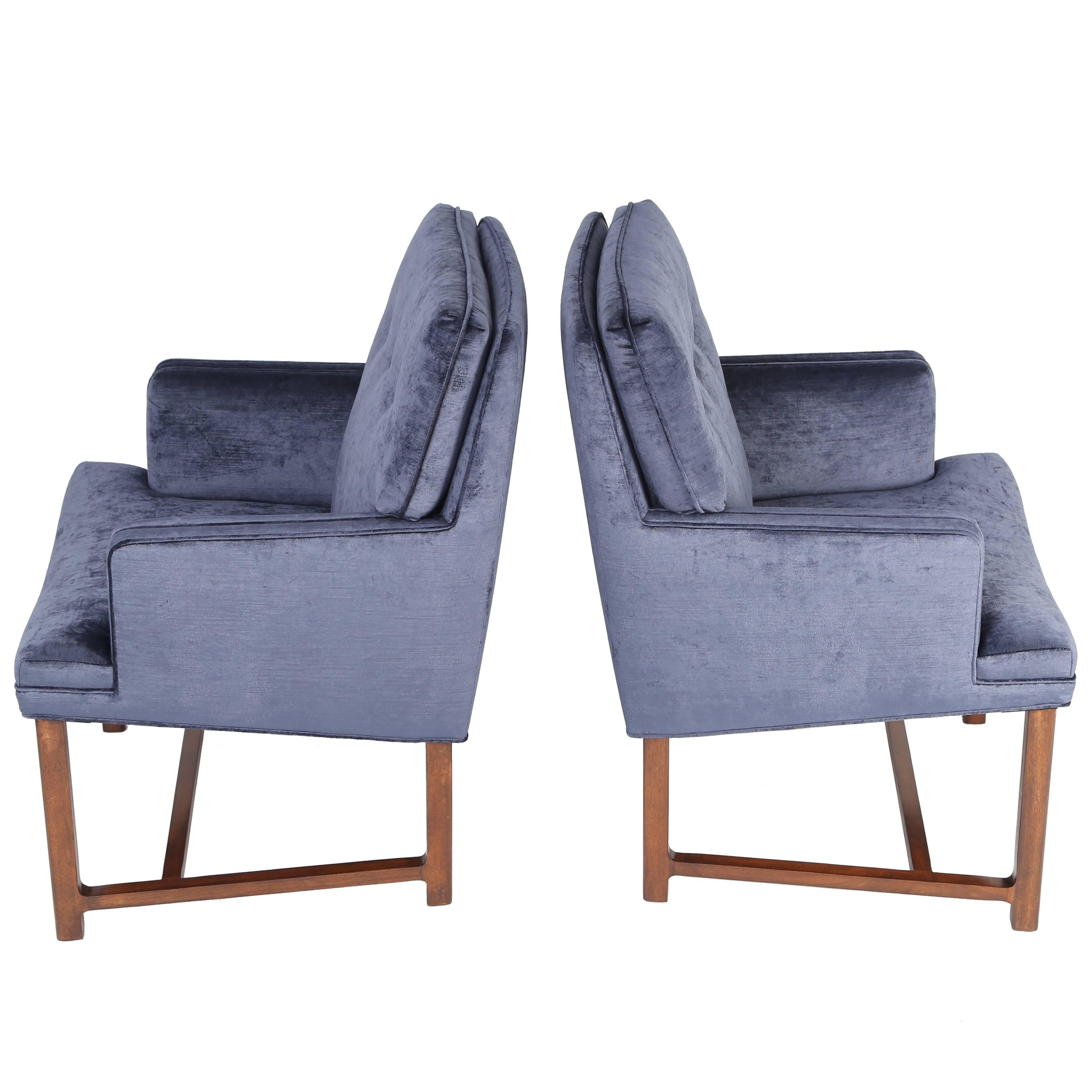 This fine pair of armchairs designed by Edward Wormley reflects Dunbar's signature high-quality construction. Sturdy and versatile, these chairs have been professionally refinished and newly reupholstered in a rich blue antiqued cotton velvet. These