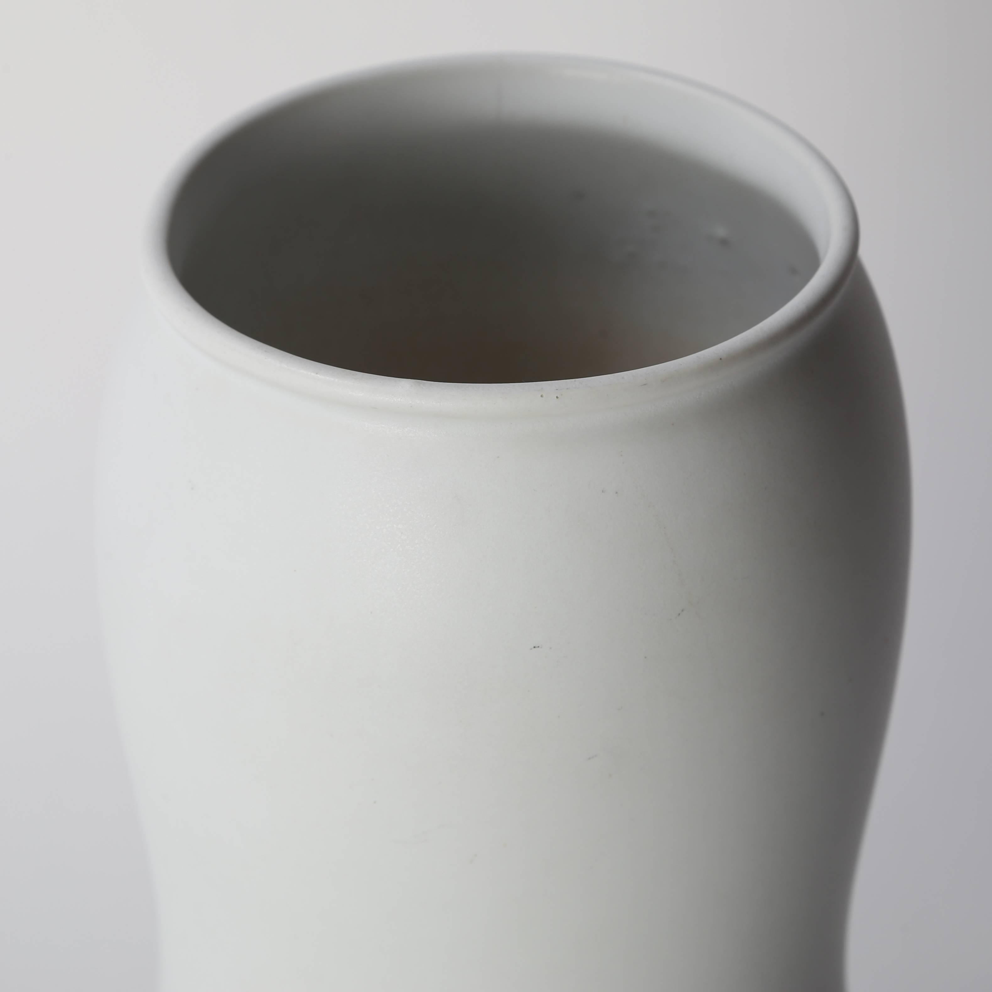 Beautiful round porcelain vase with a soft matte-white glaze designed by Stig Lindberg for Gustavsberg, circa 1950s. This example features a circular opening and gentle hourglass profile. We have several other white Gustavsberg pieces available. The