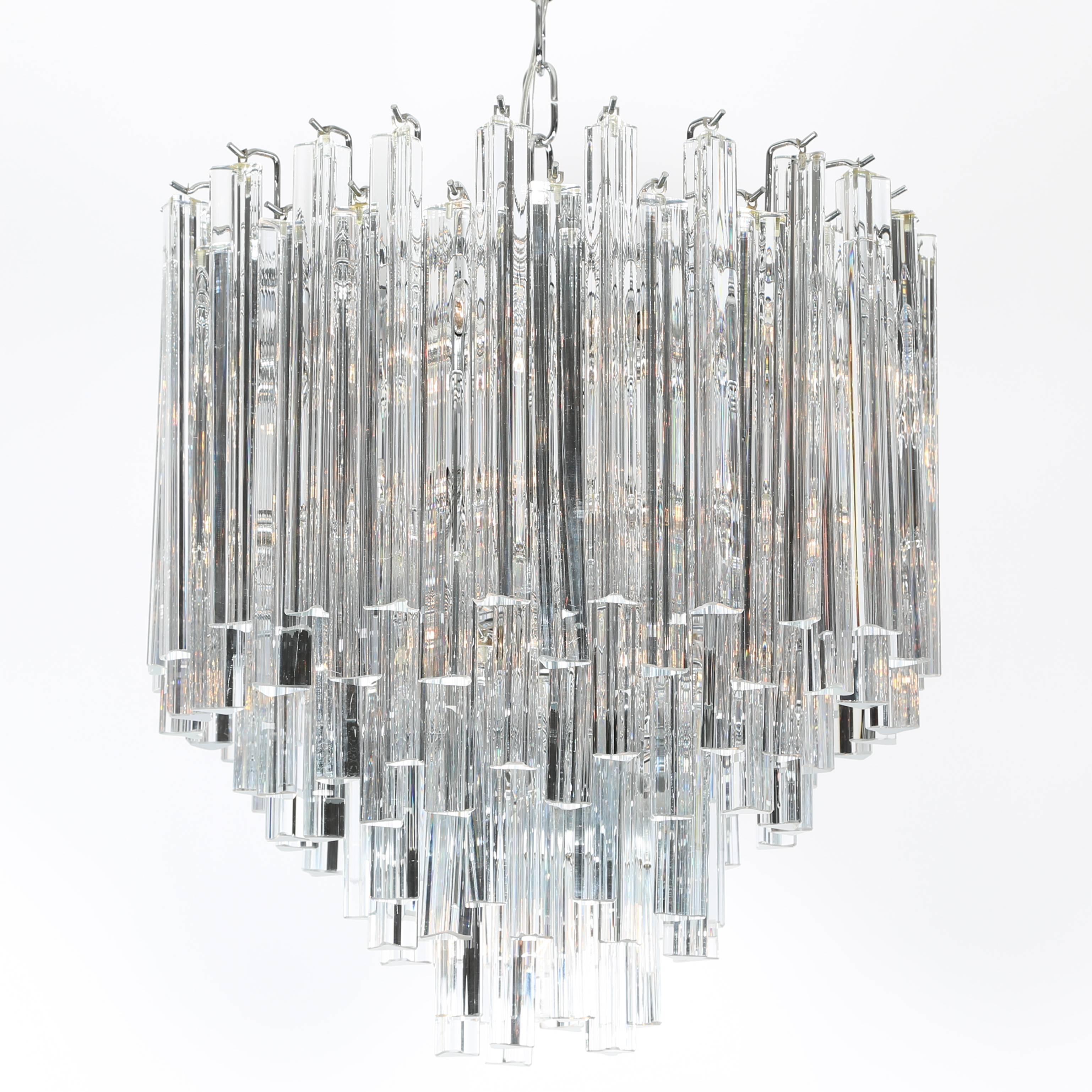 Beautiful tiered 1970s Murano chandelier with 110 triangular crystals. New polished-chrome canopy and chain. Takes 17 candelabra-base bulbs and one standard-base bulb. 20