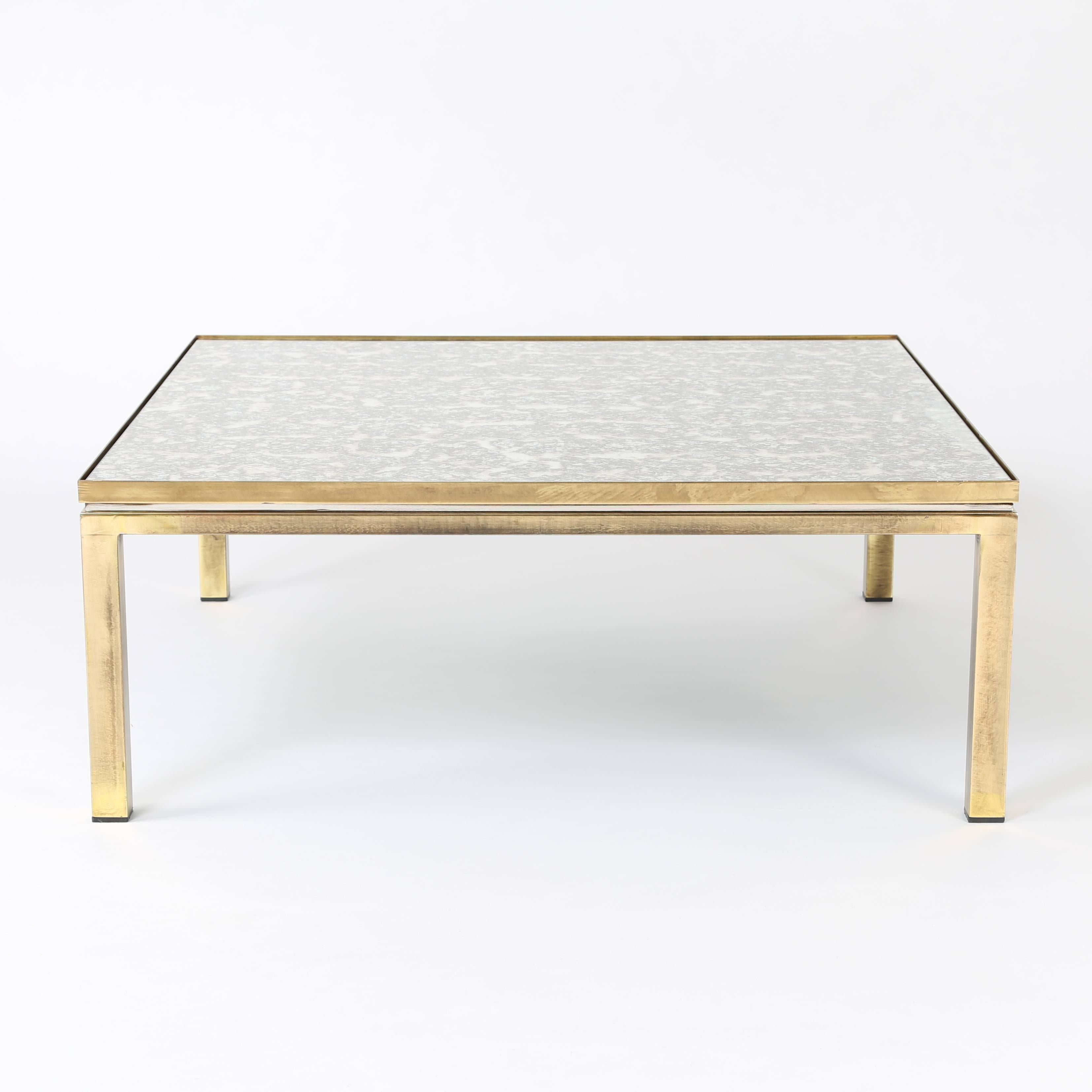 Exquisite 1970s Italian coffee table with antiqued mirror top set in a patinated-brass frame and raised on four square legs. Reveal between lower and upper frame is lined in polished chrome to give the table added depth. "Made in Italy"