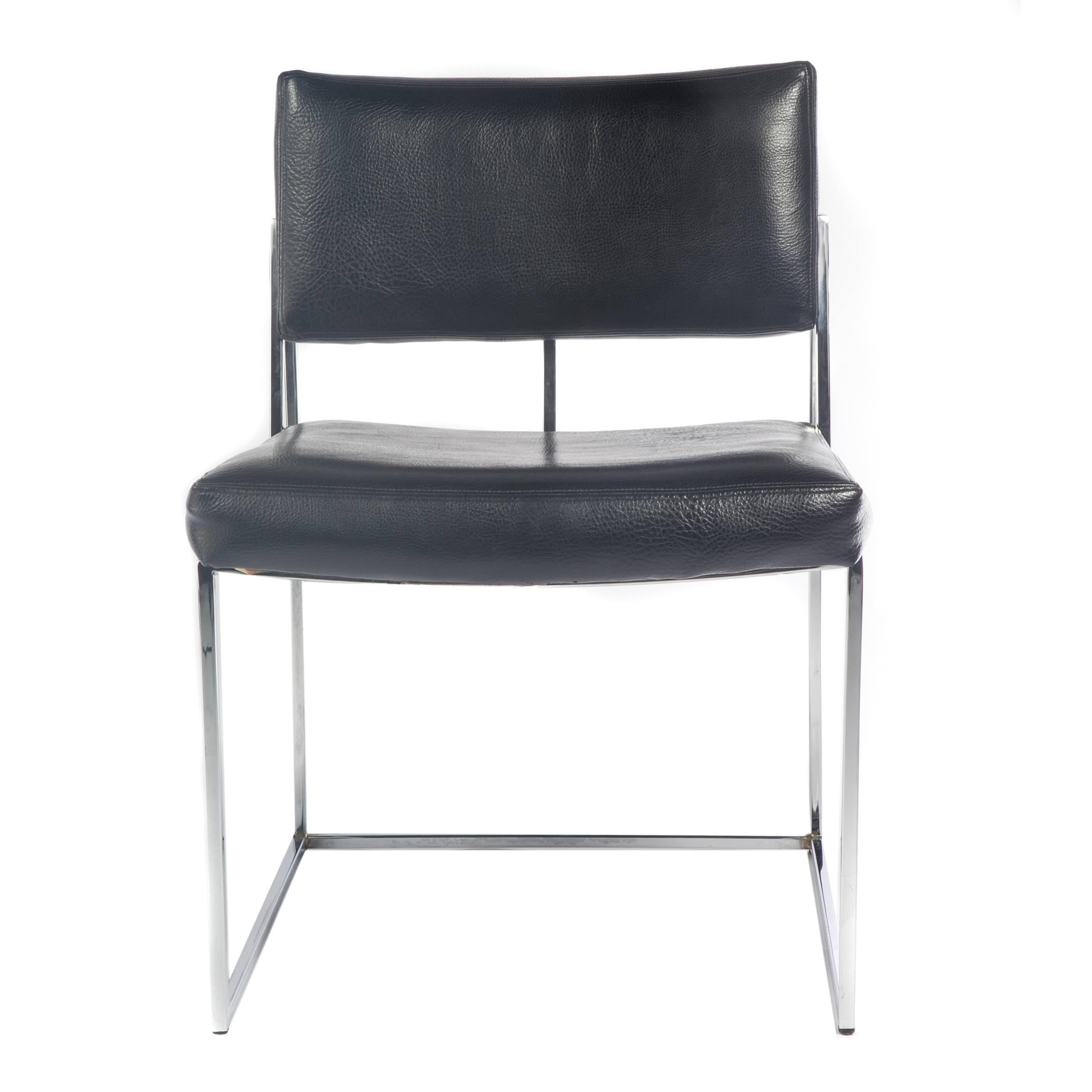 Two Milo Baughman side chairs featuring sturdy polished-chrome frames with seats and backs upholstered in original black vinyl, circa 1970s. Can be used as occasional chairs in a seating group or as dining chairs. Signed with Thayer Coggin tags.