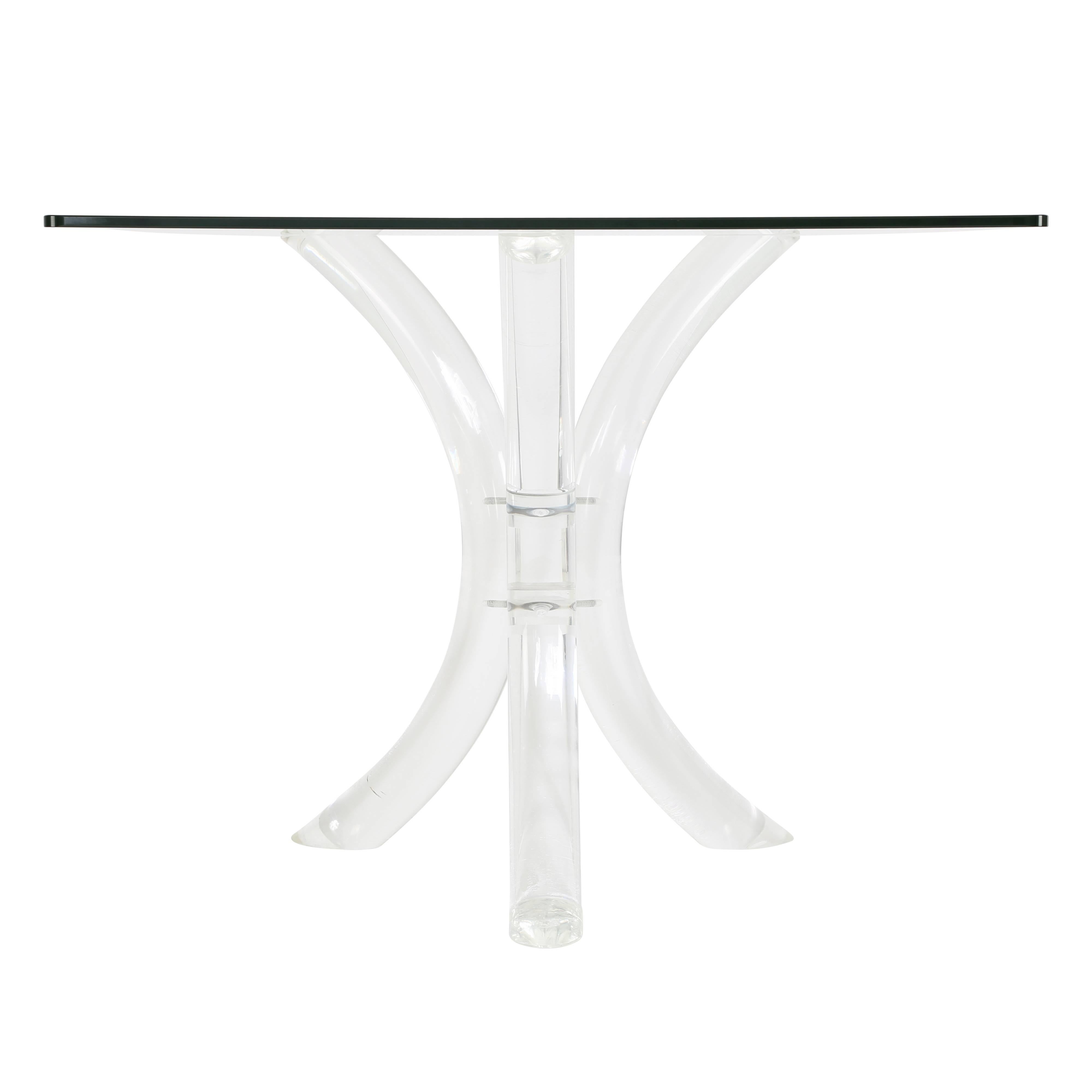 Three thick and gracefully curved Lucite legs support a 1/2