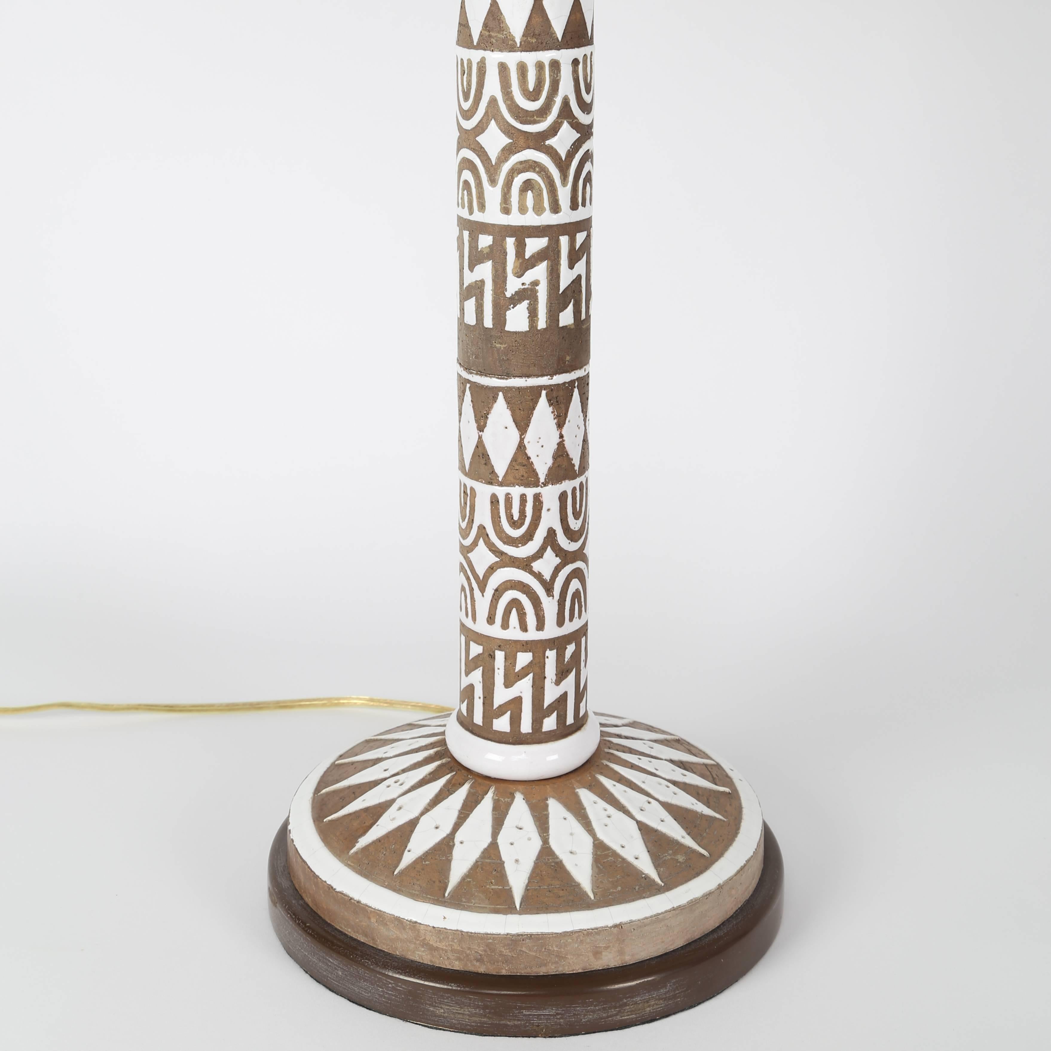 These dramatic Italian lamps feature hand-painted, white-glazed designs of diamonds, zigzags and arches on a brown ceramic background. We came by these lamps separately. However, the design, size and bases are the same. They work as a pair, and that