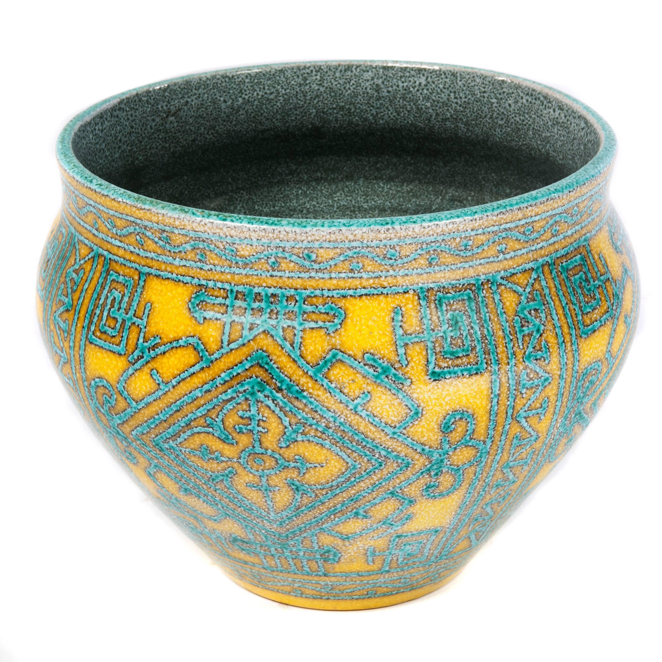 This colorful jardiniere is a fine example of 1960s Italian ceramics. The canary-yellow background is enhanced by a geometric design in turquoise; interior is blue. Signed 