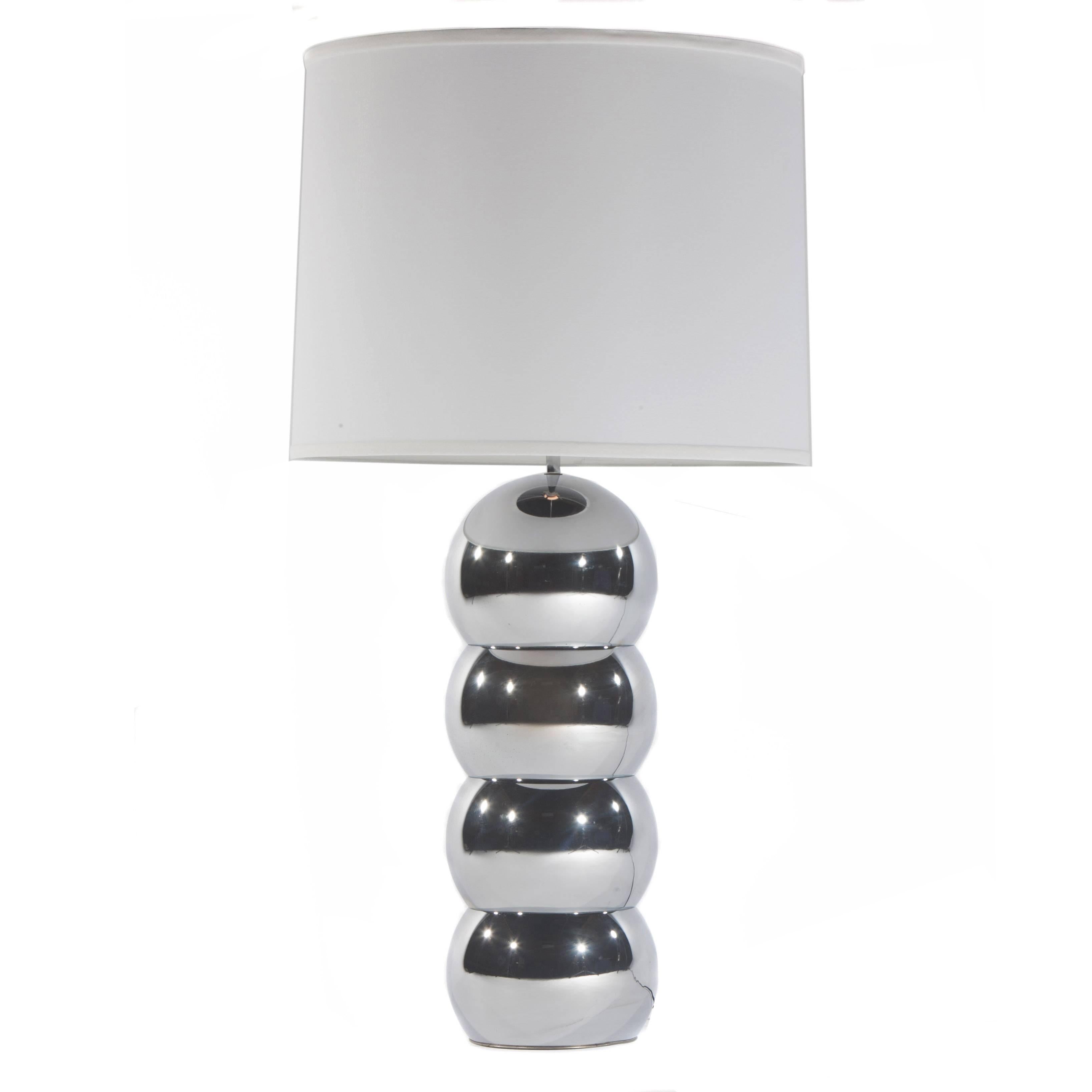 Pair of chrome stacked ball lamps by George Kovacs, circa 1970s. Classic design in great condition with new harps, linen shades and chrome finials. Takes one standard bulb; switch on neck. Overall 18.25