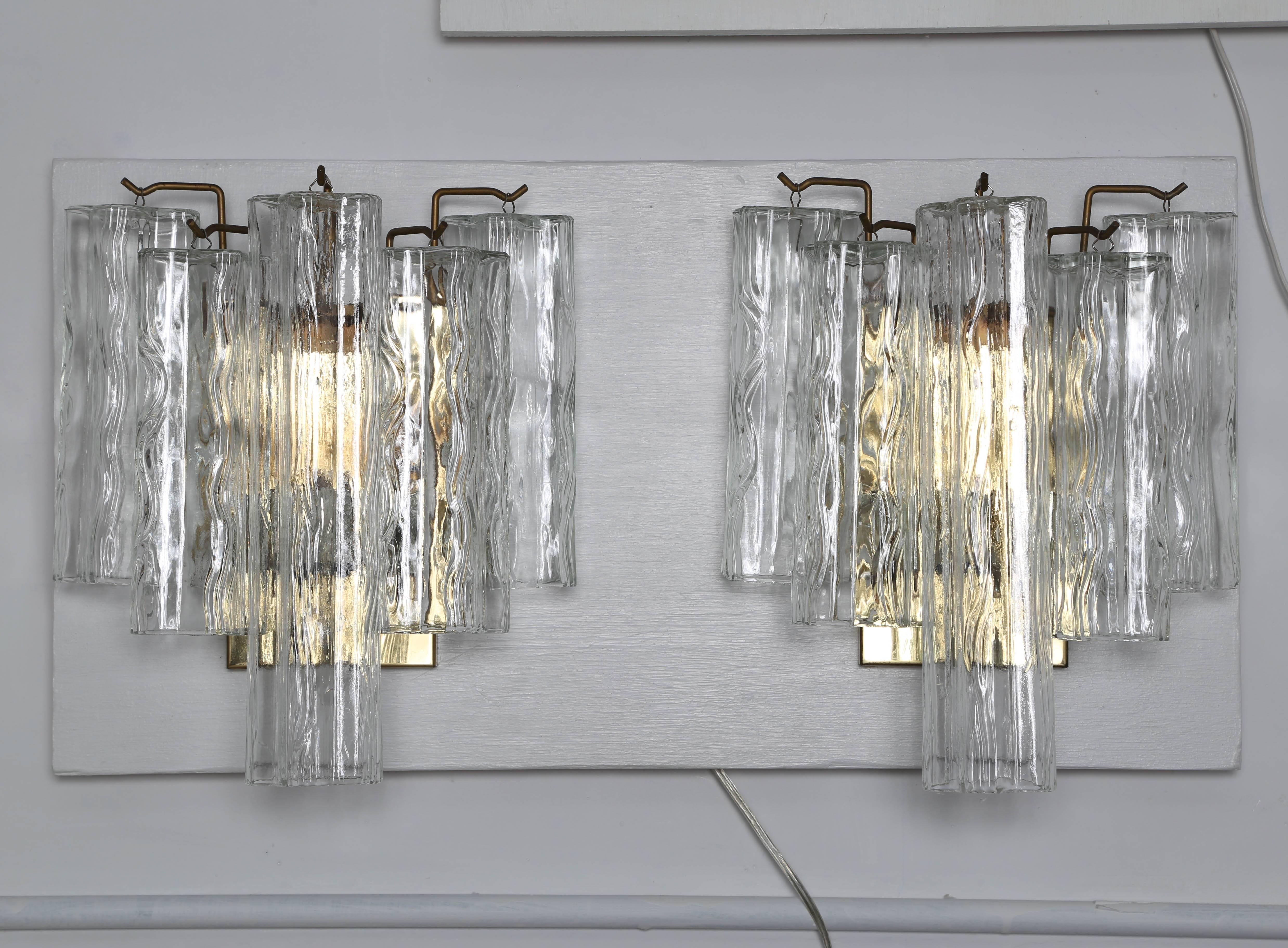 Lovely pair of sconces with brass frames each holding five Tronchi crystals, circa 1970s. Each illuminated by three candle-base bulbs. Each holds one 12-inch crystal and four 8-inch crystals. Hard-wire installation required. 

See this item in our