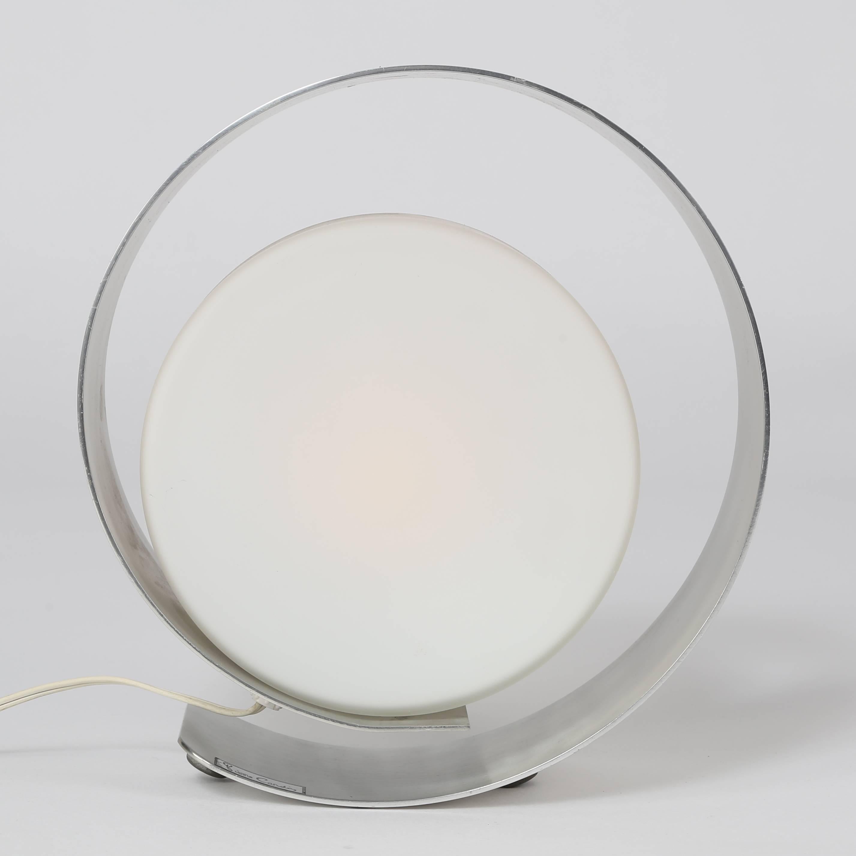 Stylish 1970s accent lamp designed by legendary fashion designer Pierre Cardin for Lumico. Frosted glass disc surrounded and supported by a circular brushed-aluminum frame. New high-low dimmer switch on cord. Takes a single standard-base bulb.