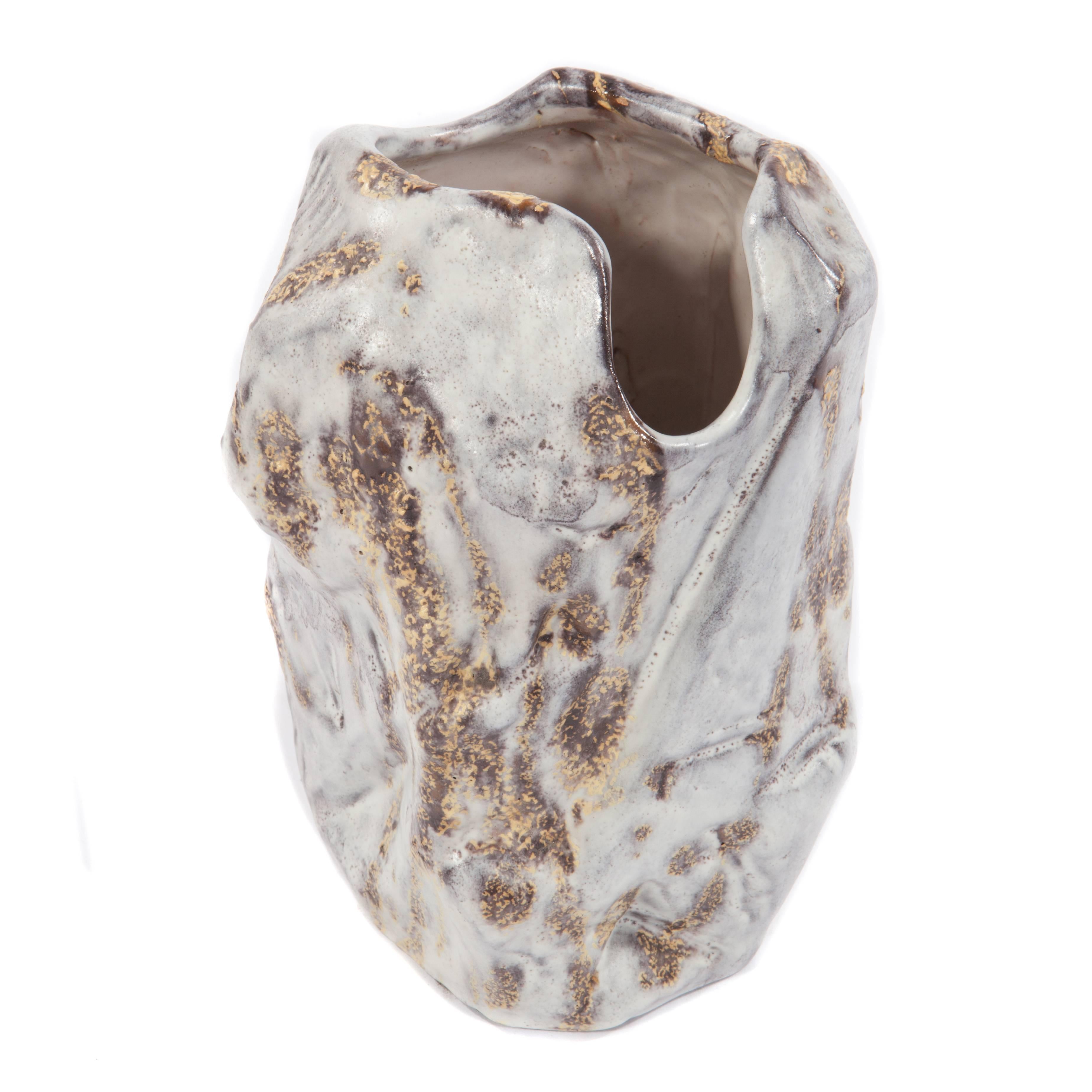 Hand-formed vase in an irregular, brutalist shape by noted Italian sculptor and artist Marcello Fantoni, circa 1960s. Irregular surface with a mottled, milky-white glaze. Signed 