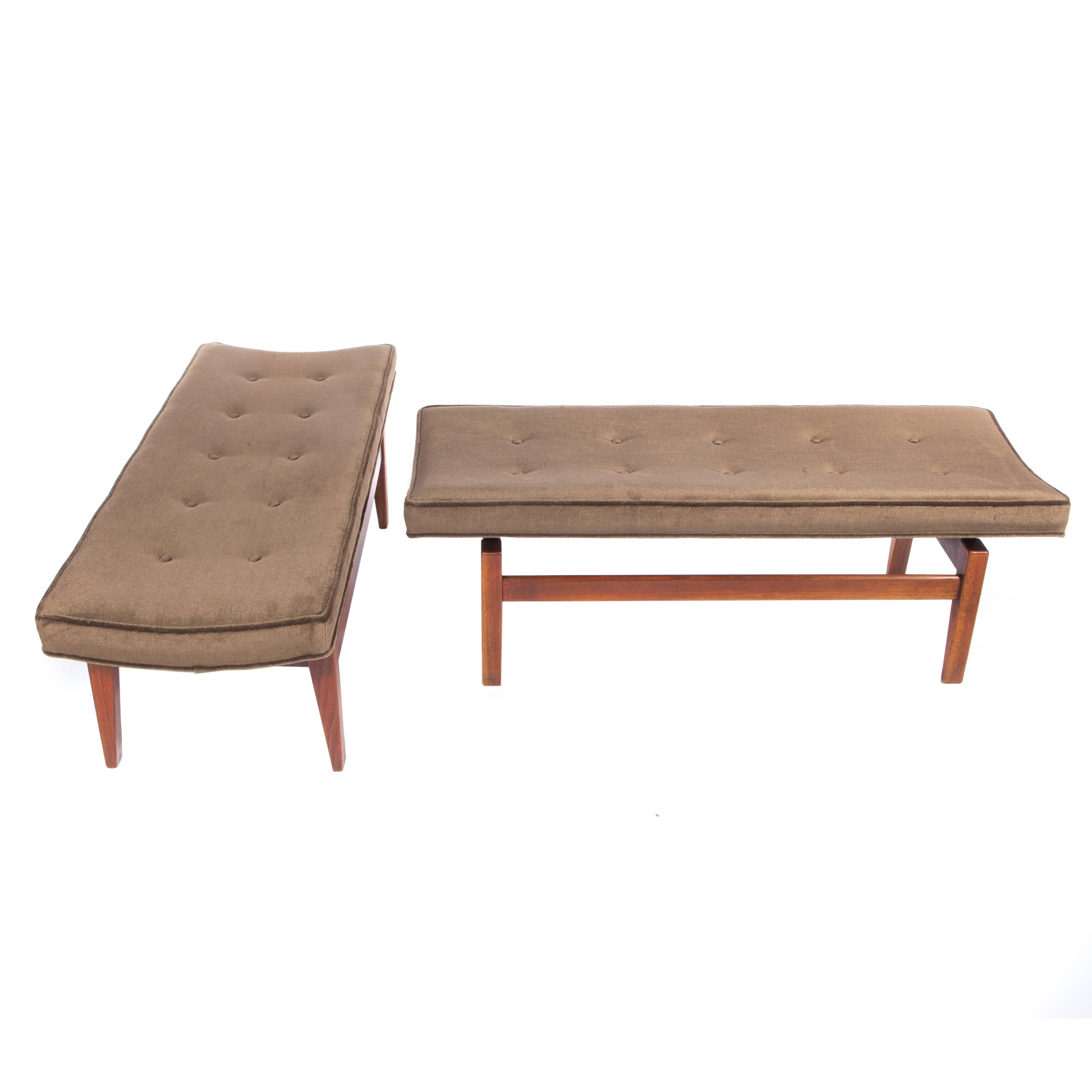 Pair of sturdy and stylish benches featuring four legs supporting a cantilevered, gently curved, button-tufted seat, circa 1960s. The walnut retains its original warm brown finish and the seats are newly reupholstered in medium-chocolate-brown