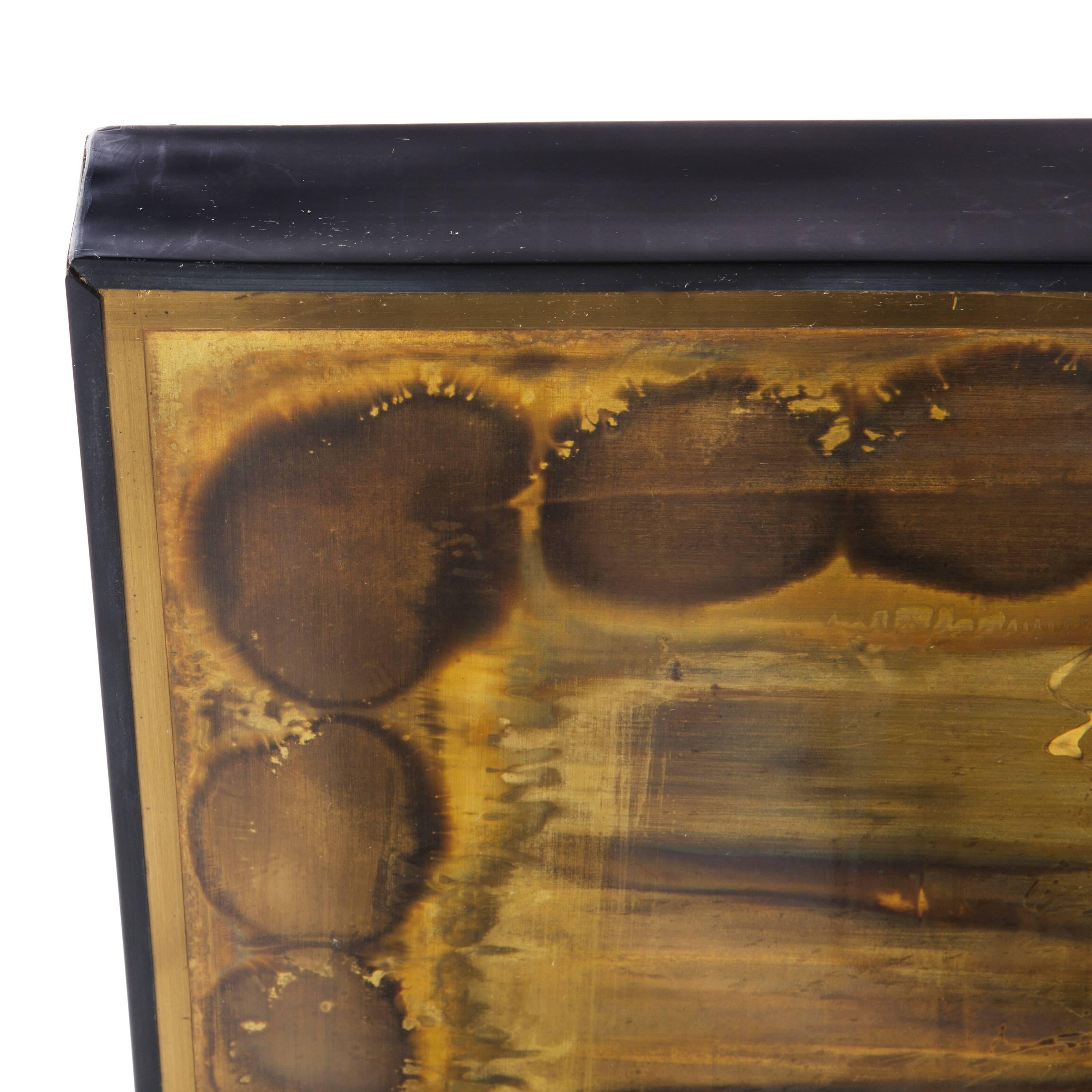 Dynamic abstract forms showcasing artist Bernhard Rohne's signature acid-etching technique, with brushed and texturized shapes and swirls in gold, amber and brass tones. One of the larger examples we have seen. Original Minimalist black vinyl frame.